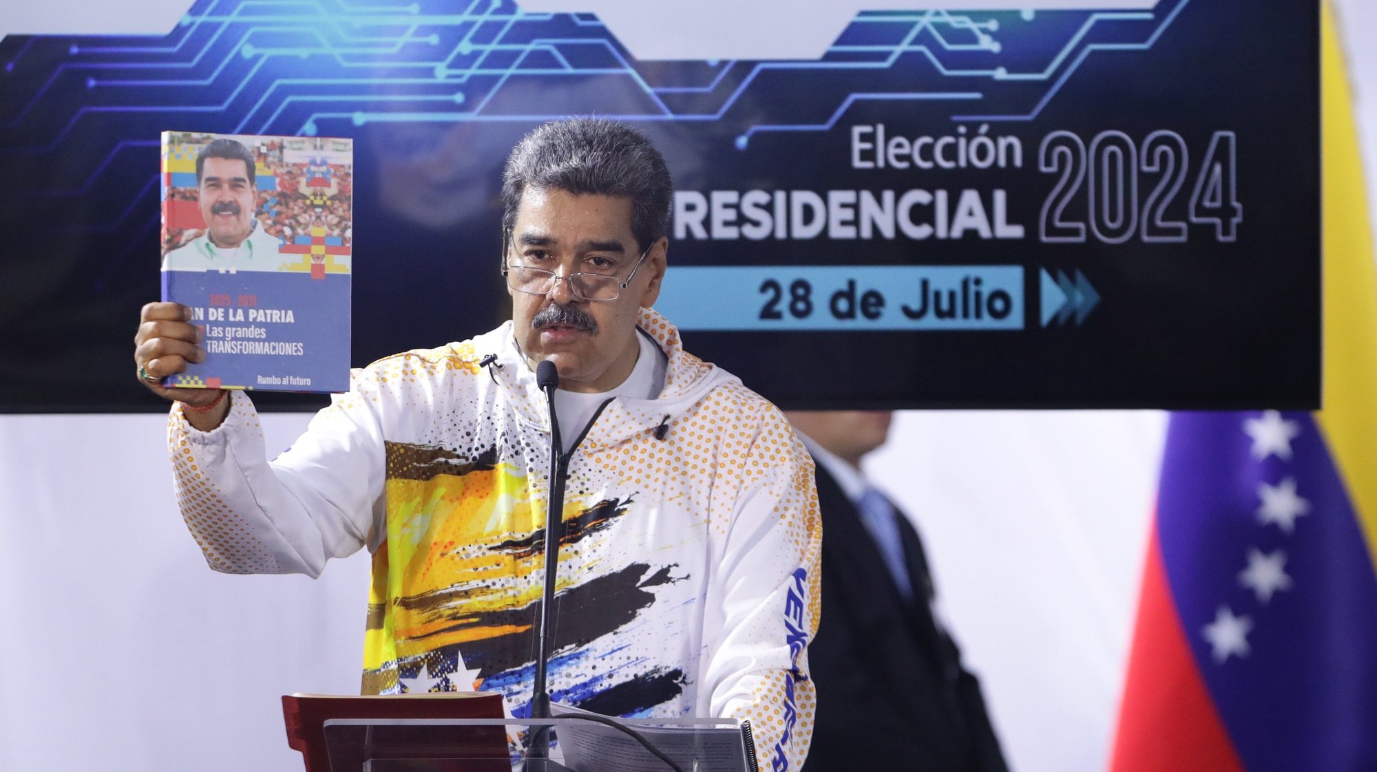 epa11243535 President Nicolas Maduro speaks after making his candidacy official for the presidential elections on July 28, in which he will compete for a third period in power, at the headquarters of the National Electoral Council (CNE) in Caracas, Venezuela, 25 March 2024. The Chavista leader went to the headquarters of the electoral body after participating in a march called by the ruling United Socialist Party of Venezuela (PSUV) in support of his registration, with which he becomes the tenth politician to make his aspiration official, a few hours before the deadline established in the schedule for the presentation of candidatures.  EPA/Rayner Pena R.