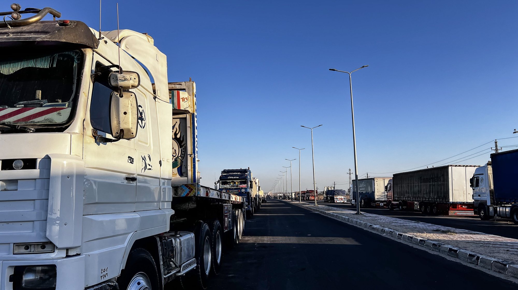 epa11325260 Trucks carrying humanitarian aid to Gaza line up waiting to move towards Rafah border crossing, from Arish, Egypt, 07 May 2024, after Israel took control of the Gazan side of the Rafah crossing. The Israel Defence Forces (IDF) said on 07 May that its ground troops began an operation targeting Hamas militants and infrastructure within specific areas of eastern Rafah, taking operational control of the Gazan side of the Rafah crossing based on intelligence information. More than 34,600 Palestinians and over 1,455 Israelis have been killed, according to the Palestinian Health Ministry and the IDF, since Hamas militants launched an attack against Israel from the Gaza Strip on 07 October 2023, and the Israeli operations in Gaza and the West Bank which followed it.  EPA/STR