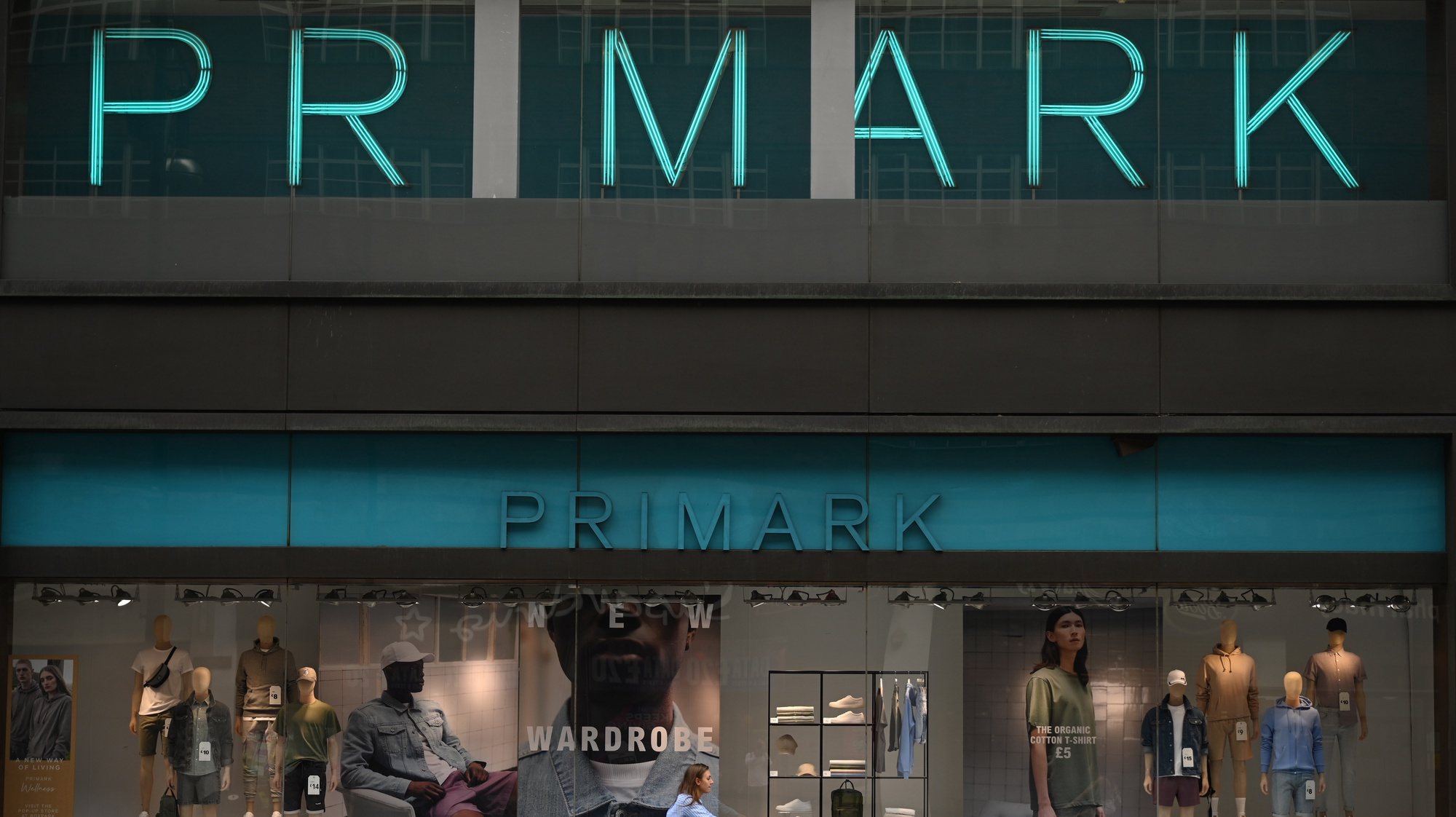 epa08447286 A woman cycles pass a shut Primark store on Oxford Street in London, Britain, 27 May 2020. Non-essential shops have been given the go-ahead to open their doors again in England from 15 June.  EPA/NEIL HALL