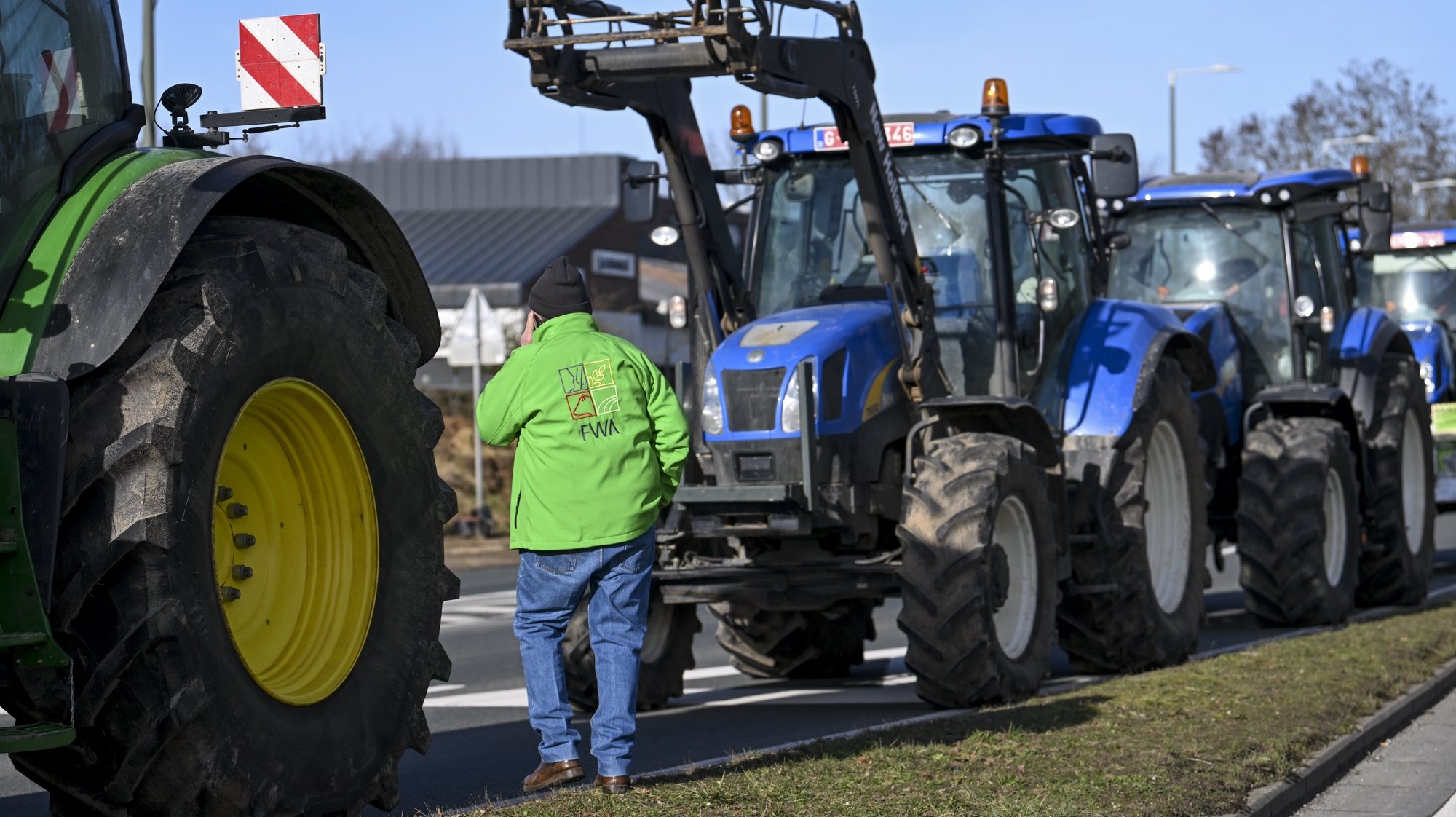 epa11108327 Farmers use their tractors to put up filtering roadblock during a protest action at a Walloon roundabout at Mont-Saint-Guibert, Belgium, 27 January 2024. The agricultural sector aims to highlight through these actions declining incomes, overly complex legislation, and administrative overload. The discontent among farmers, initially sparked in France, has spilled over into several European countries, including Belgium, particularly in the Walloon region.  EPA/FREDERIC SIERAKOWSKI