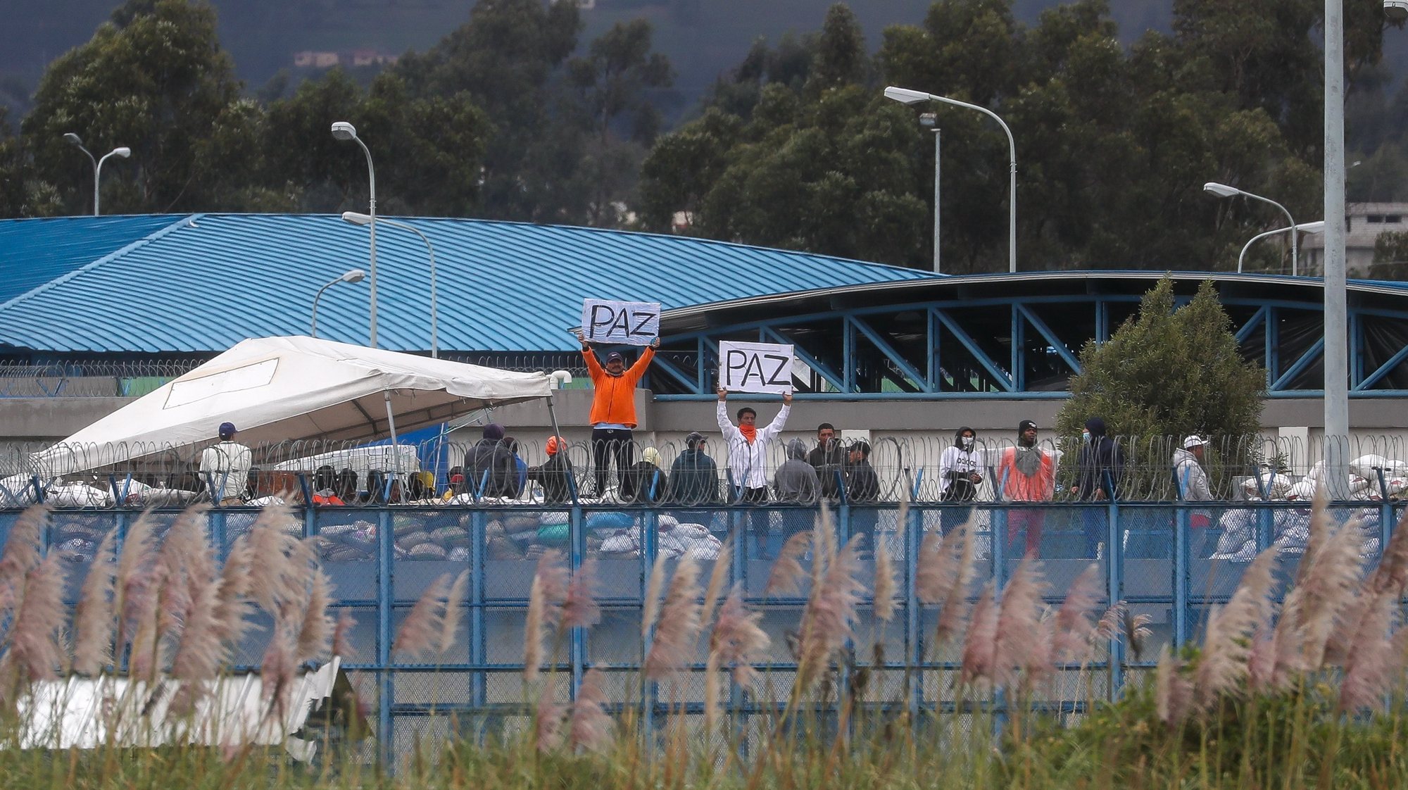 epa11068283 Inmates hold up signs as they remain on the roof of the Sierra Centro Norte Cotopaxi Social Rehabilitation Center, in Latacunga, Ecuador, 10 January 2024. The President of Ecuador, Daniel Noboa, assured that his country is in a state of war after the violent actions carried out by organized crime gangs that led him to declare internal armed conflict, and he said that he does not plan to negotiate or give in to these groups, which his government has described as &quot;terrorists&quot;.  EPA/Jose Jacome