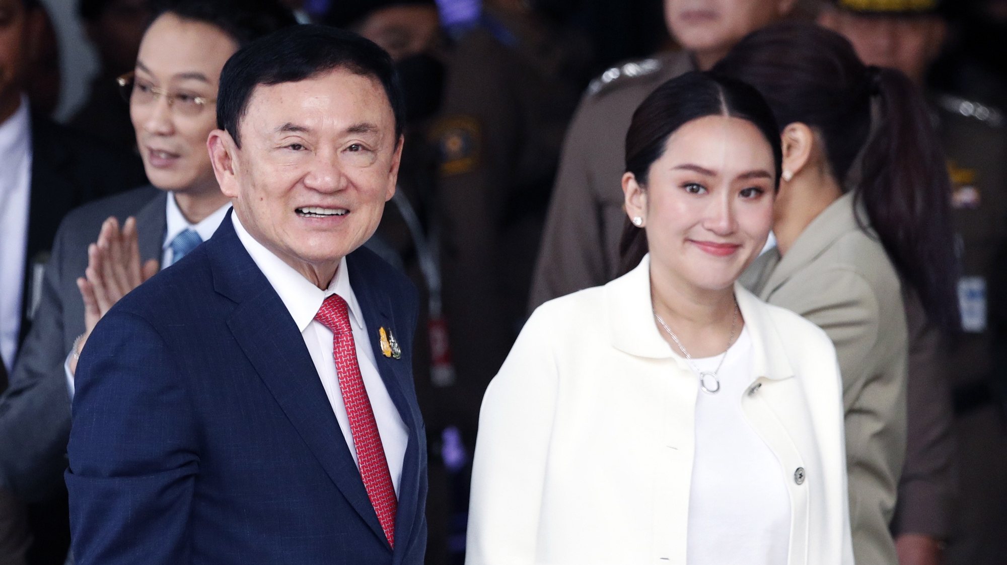 epa10812952 Former Thai prime minister Thaksin Shinawatra smiles next to his daughter and Pheu Thai Party prime ministerial candidate Paetongtarn Shinawatra upon his arrival at Don Mueang airport in Bangkok, Thailand, 22 August 2023. Shinawatra returned to Thailand after living in self-imposed exile for 15 years, following his overthrowing by a military coup on 19 September 2006. The former prime minister is expected to face imprisonment with a combined jail term of five years.  EPA/RUNGROJ YONGRIT