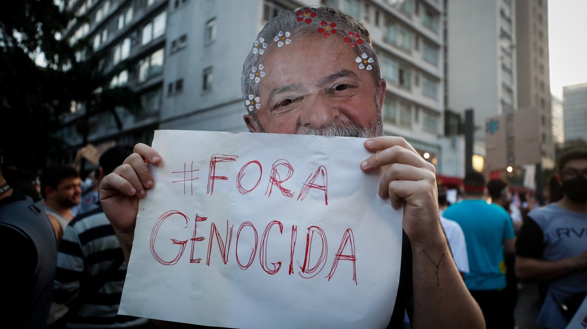 epa09236293 A man wearing a mask of former Brazilian President Luiz Inacio Lula da Silva holds a placard reading &#039;#Out, Genocidal&#039; during a protest against Brazilian President Jair Bolsonaro and his handling of the COVID-19 pandemic crisis, in Sao Paulo, Brazil, 29 May 2021.  EPA/Fernando Bizerra
