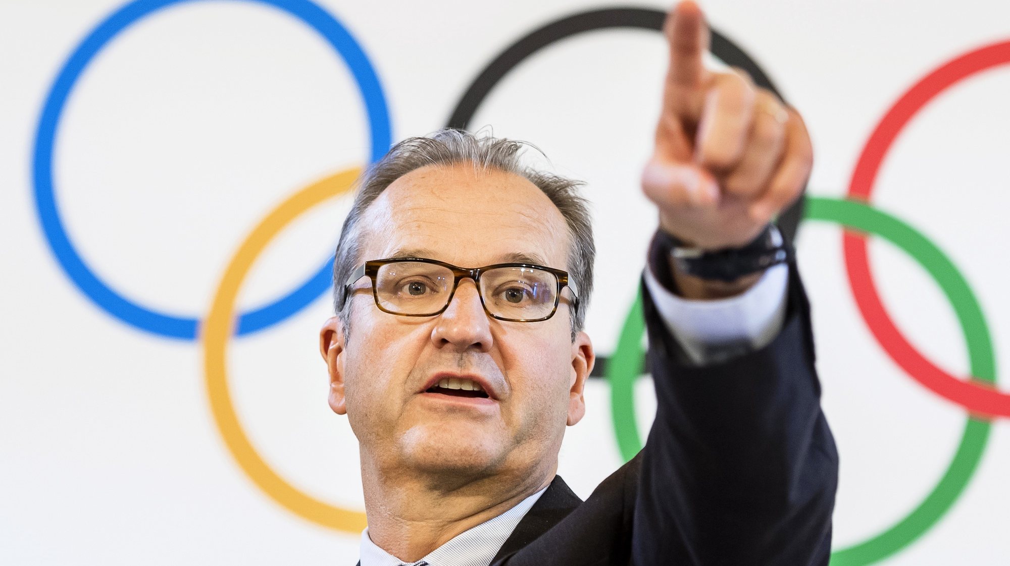 epa07661084 Mark Adams, spokesman for the International Olympic Committee (IOC), gestures during a press conference after the IOC executive board meeting in Lausanne, Switzerland, 20 June 2019.  EPA/JEAN-CHRISTOPHE BOTT