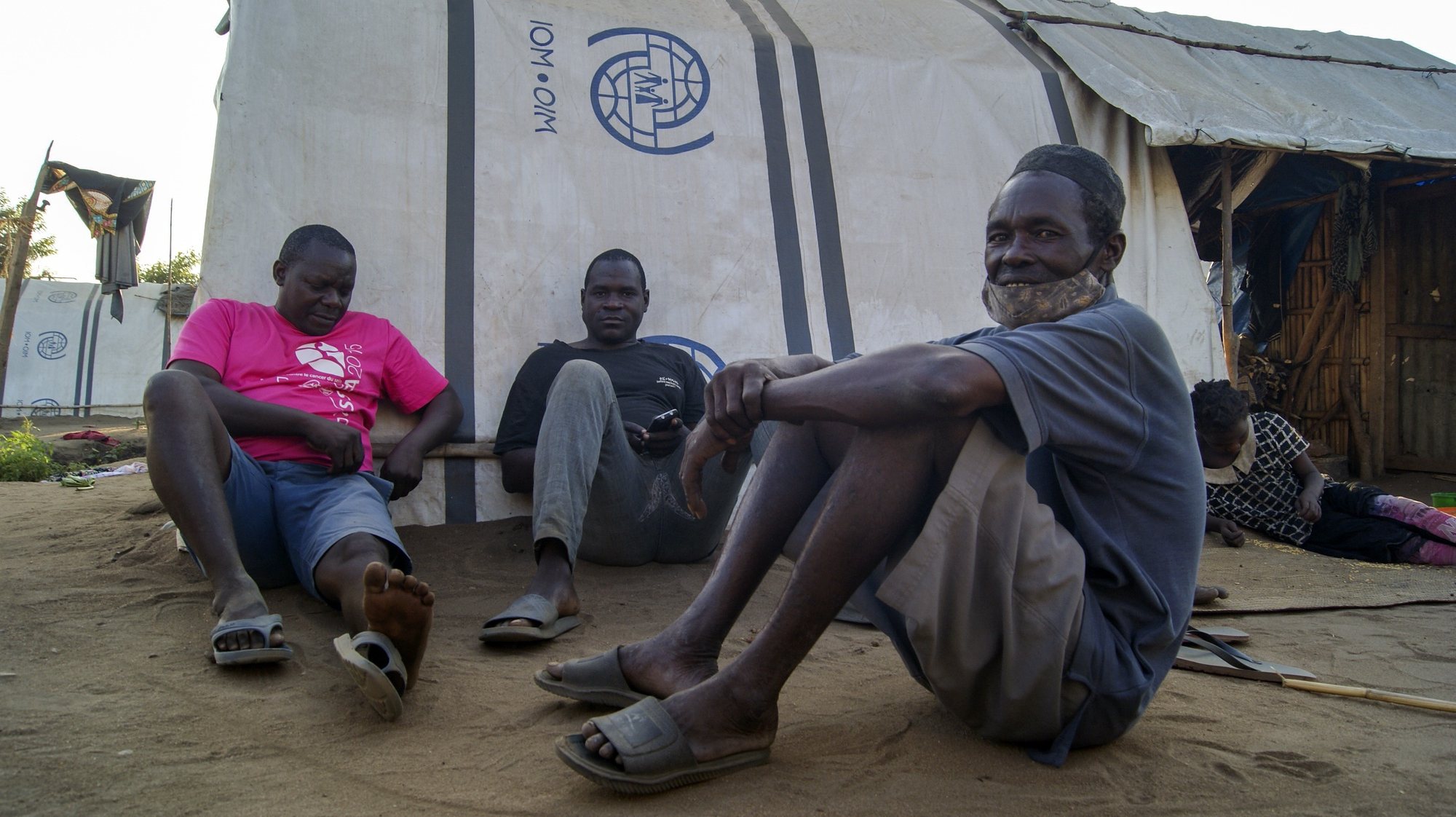 Men standing in one of the shelter camps in Metuge, a space housing displaced people fleeing armed violence in northern Mozambique. Cabo Delgado, Mozambique, 16 August 2021 (issue on 17 August 2021). Following the attacks, which have terrorized Cabo Delgado province since 2017, there are more than 3,100 deaths, according to the ACLED conflict registration project, and more than 817,000 displaced people, according to Mozambican authorities. LUISA NHANTUMBO/LUSA