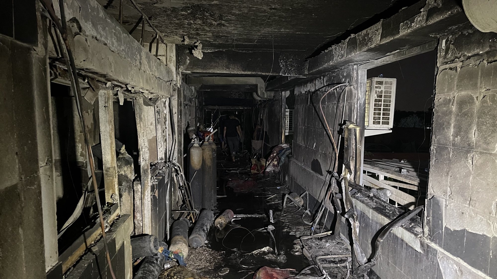 epa09157833 Aftermath of a fire at Ibn Al-Khatib Hospital, south of Baghdad, Iraq, 25 April 2021. At least 27 people died and dozens were injured when a fire broke out following the explosion of oxygen tanks at the hospital equipped to treat COVID-19 patients on 24 April.  EPA/MURTAJA LATEEF