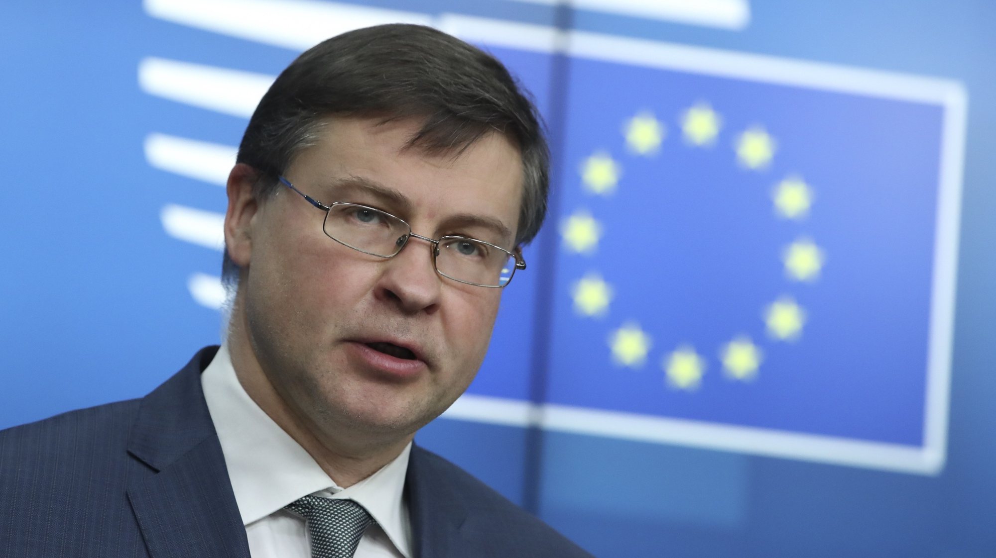 epa09077911 European Commission Vice-President Valdis Dombrovskis speaks during a news conference following a European Union finance ministers meeting in Brussels, Belgium, 16 March 2021.  EPA/YVES HERMAN / POOL