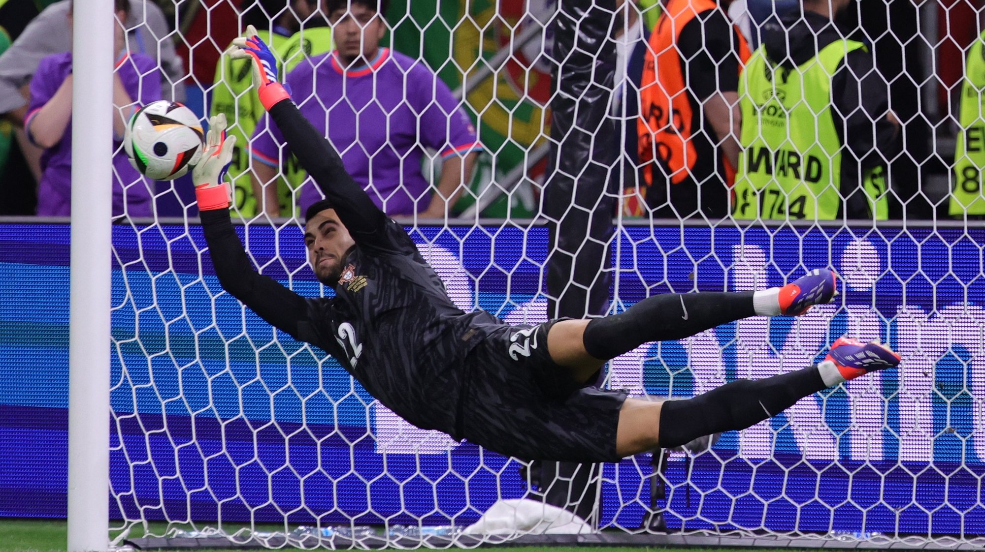 epa11451492 Goalkeeper Diogo Costa of Portugal saves a penalty during the penalty shootout of the UEFA EURO 2024 Round of 16 soccer match between Portugal and Slovenia, in Frankfurt Main, Germany, 01 July 2024.  EPA/OLIVIER MATTHYS