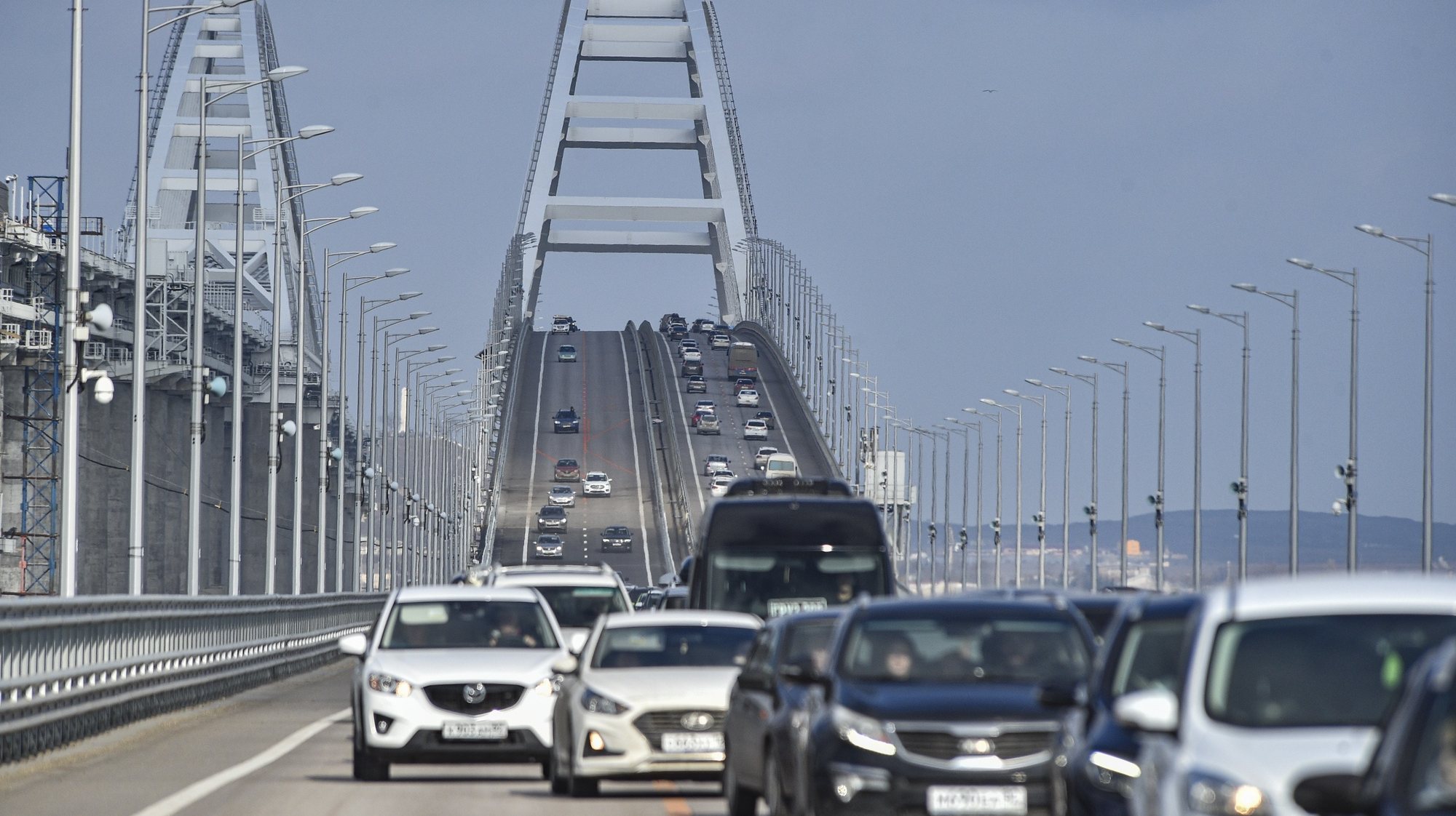 epa10485423 Cars drive across the Crimean bridge in Crimea, 23 February 2023. Automobile traffic resumed on all lanes of the Crimean bridge on 23 February, 39 days ahead of schedule, the press service of Russia&#039;s Deputy Prime Minister Marat Khusnullin announced. The motorway of the Crimean Bridge was damaged by an explosion last October. To restore the bridge, some 2,442 tons of metal structures were manufactured, which were delivered from Tyumen, Voronezh and Kurgan. The builders needed to replace four spans on both sides of the bridge, lay two layers of asphalt concrete pavement and install lighting masts.  EPA/STRINGER