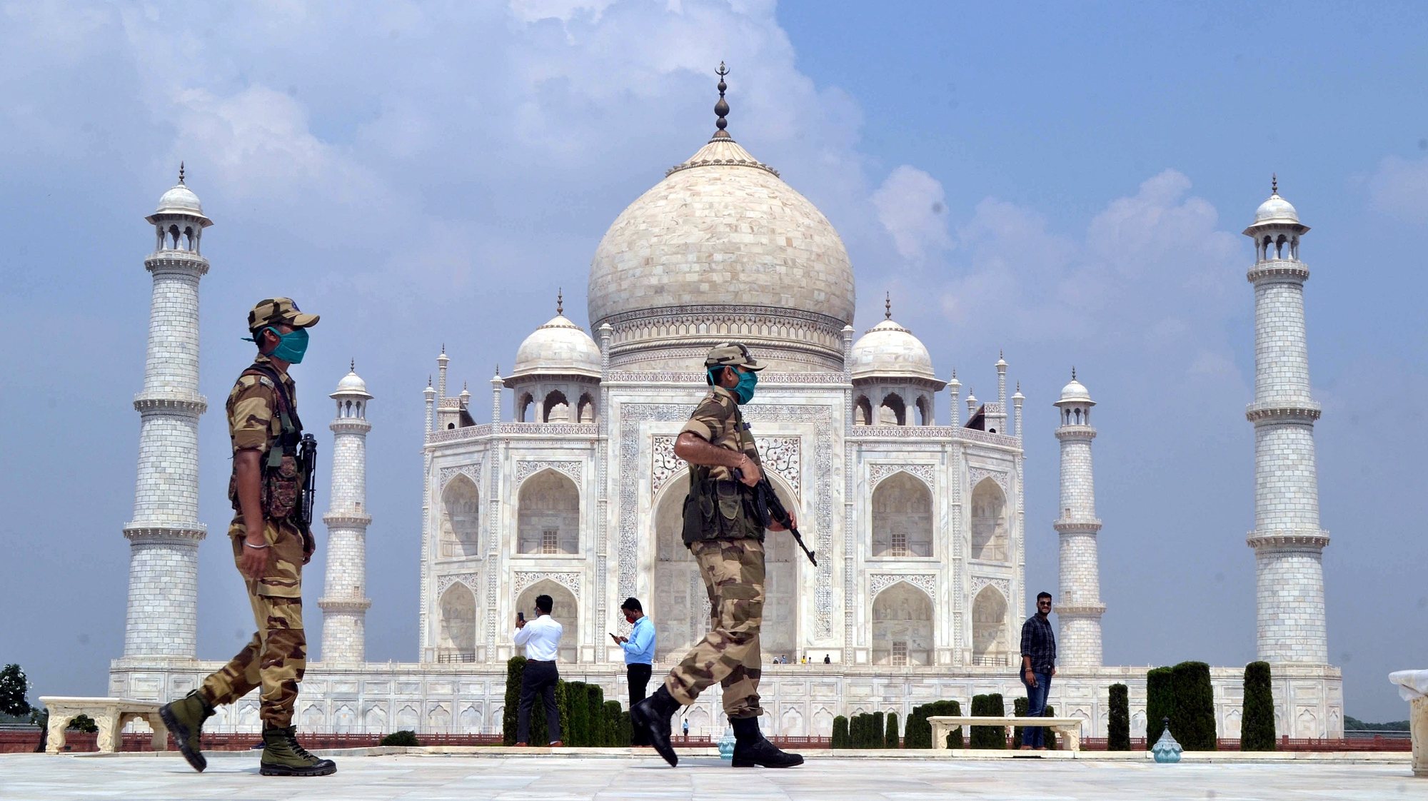 epa08685840 Indian security personnel stand guard at the Taj Mahal in Agra, Uttar Pradesh, India, 21 September 2020. The Taj Mahal reopened with increased safety measures after it was closed down by the authorities for six months amid the COVID-19 pandemic.  EPA/STR