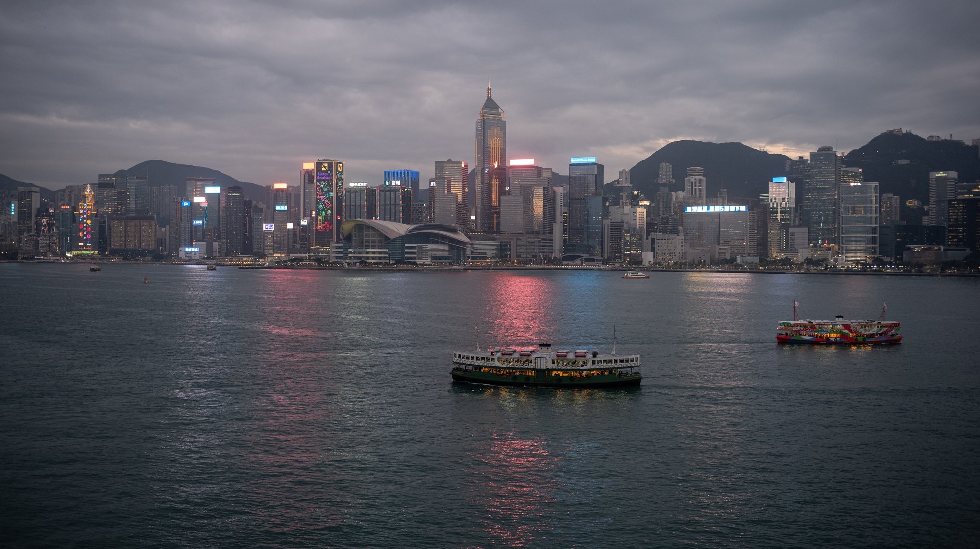 epa09696862 Residential and commercial buildings stand in the Wanchai and Causeway Bay districts in Hong Kong, China, during sunset 20 January 2022. Victoria Harbour separates the Kowloon Peninsula with the island of Hong Kong.  EPA/JEROME FAVRE