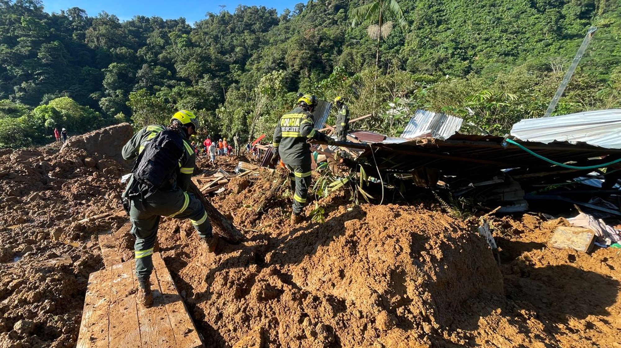epa11074105 A handout photo made available by the National Police shows rescue workers in the area where a landslide occurred on a road near the town Carmen de Atrato, Choco department, Colombia, 12 January 2024 (issued 13 January 2024). At least 23 people died and 25 others were injured on 12 January in two landslides on a road near the town of Carmen de Atrato, in the western Colombian department of Choco, mayor of Carmen de Atrato, Jaime Herrera, confirmed. The landslide occurred on the road between Medellin and Quibdo, the capital of Choco, apparently caused by a flood, and buried several vehicles.  EPA/NATIONAL POLICE HANDOUT EDITORIAL USE ONLY/NO SALES HANDOUT EDITORIAL USE ONLY/NO SALES HANDOUT EDITORIAL USE ONLY/NO SALES