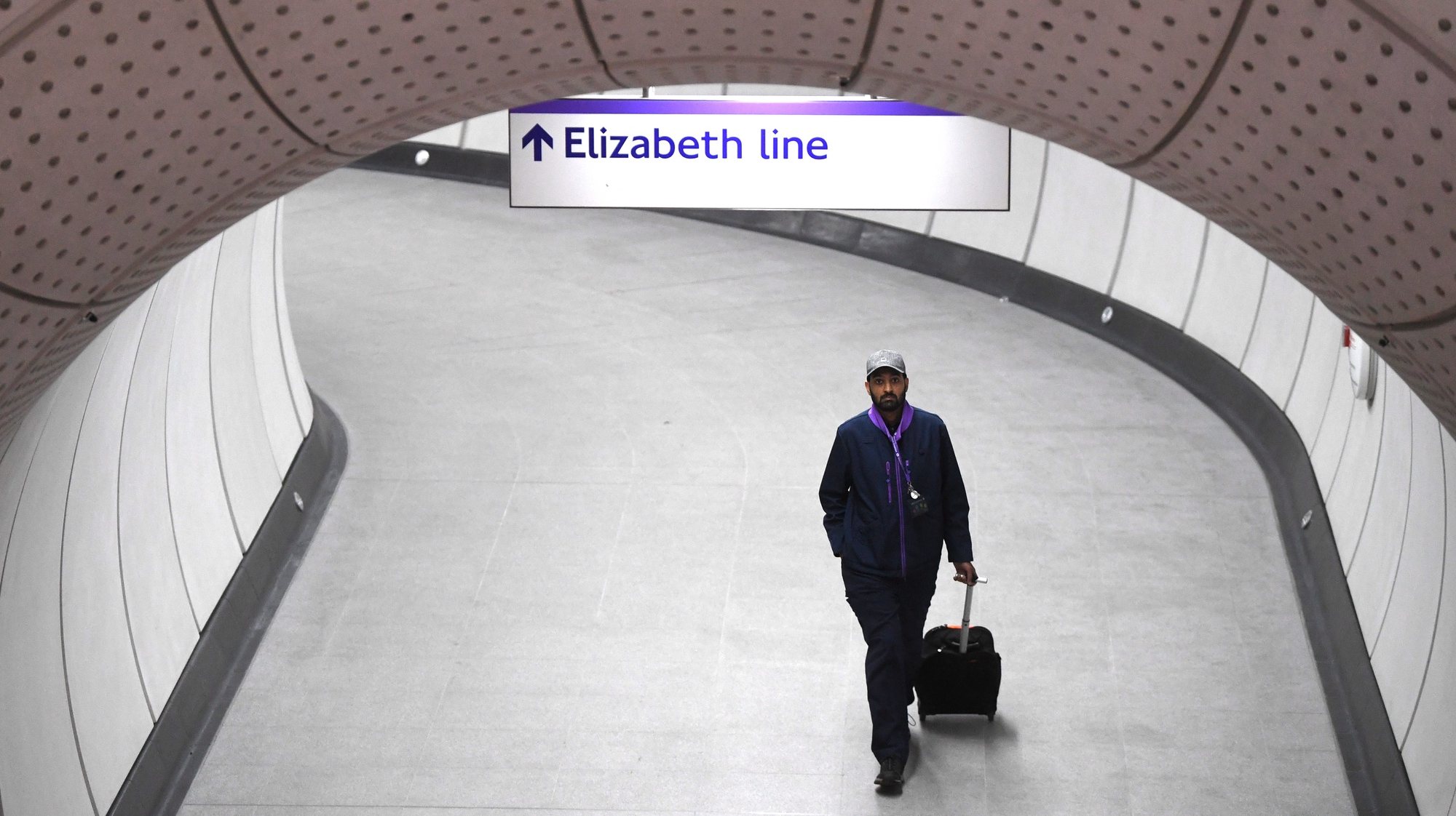 epa09941335 A man walks through an empty station on the underground section of the Elizabeth Line at Liverpool Street in London, Britain, 11 May 2022 (issued 12 May 2022). Transport for London (TfL) has announced the delayed and over-budget Crossrail project will open to passengers on 24 May 2022. Known as the Elizabeth line, it was scheduled to start in December 2018 but the 18.8-billion-GBP project has missed multiple targets amid rising costs.  EPA/NEIL HALL