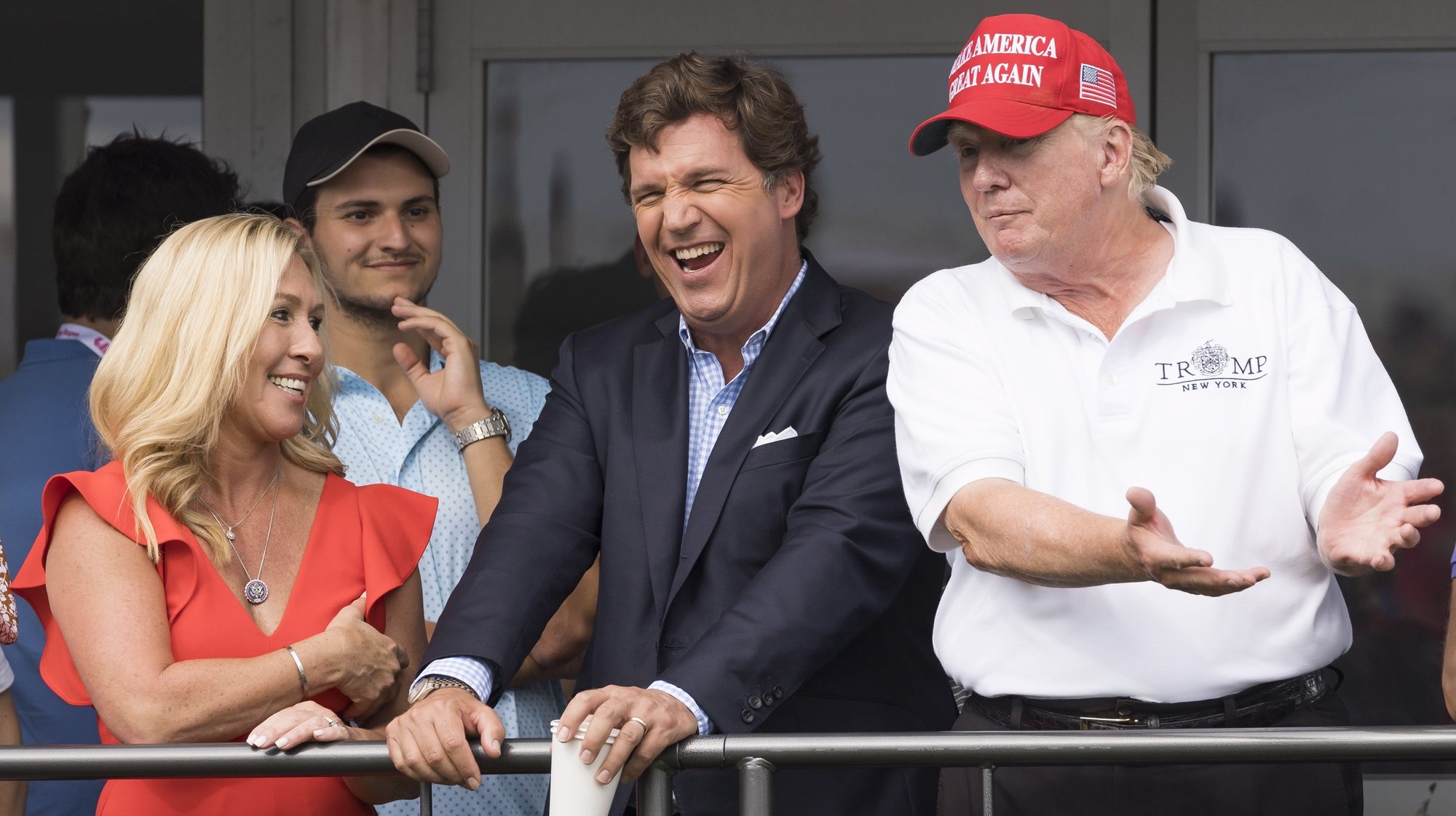 epaselect epa10100951 (L-R) Republican Congresswoman Majorie Taylor Greene of Georgia, Fox News television personality Tucker Carlson, and former US President Donald J. Trump watch the third round of the LIV Golf Bedminster invitational, part of the new LIV Golf Invitational Series, at the Trump National Golf Club in Bedminster, New Jersey, USA, 31 July 2022.  EPA/JUSTIN LANE