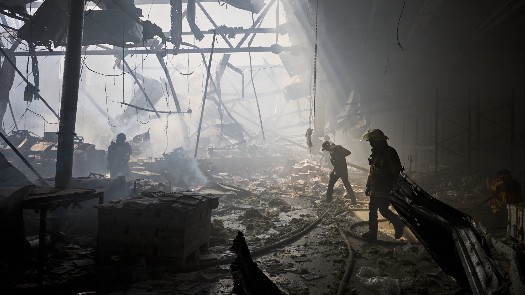epaselect epa11363335 Ukrainian rescuers work at the site of a shelling on a printing house in Kharkiv, Ukraine, 23 May 2024, amid the Russian invasion. At least seven people were killed and 16 others were wounded in the rocket attack, according to the report of the head of the Kharkiv Military Administration Oleg Synegubov.  EPA/SERGEY KOZLOV