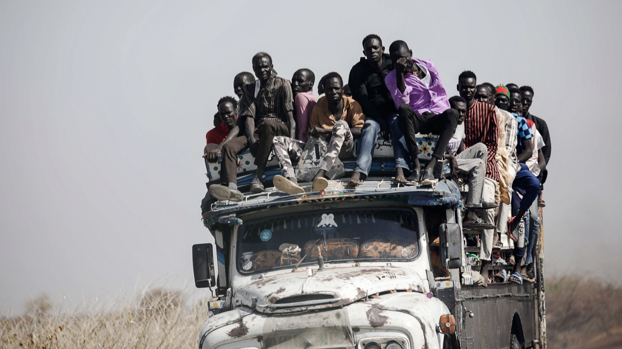 epa11000674 epa10622722 Sudanese refugees and South Sudanese returnees travel atop a truck transporting them from the border towards the Upper Nile State town of Renk, South Sudan, 12 May 2023. Fleeing the armed conflict between the Sudanese military and the RSF (Rapid Support Forces) militia which started last 15 April, some 40 000 people have arrived into South Sudan according to the UNHCR. Most of the refugees are part of the some 800 000 South Sudanese who had fled the war in South Sudan in the first place and they are returning to a country which is barely out of conflict itself with tensions still remaining in many areas and more than 2 million internally displaced people. The scarcity of food and water and the military escalation had made the stay of most civilians impossible in Sudan. Upon arriving at Joda border crossing the refugees head to a transit area set up by the UNHCR in the small town of Renk, where various UN agencies assist them with registration, food, health check and logistics to either leave Renk which is not equipped to house a large refugee population.  EPA/AMEL PAIN  EPA-EFE/AMEL PAIN