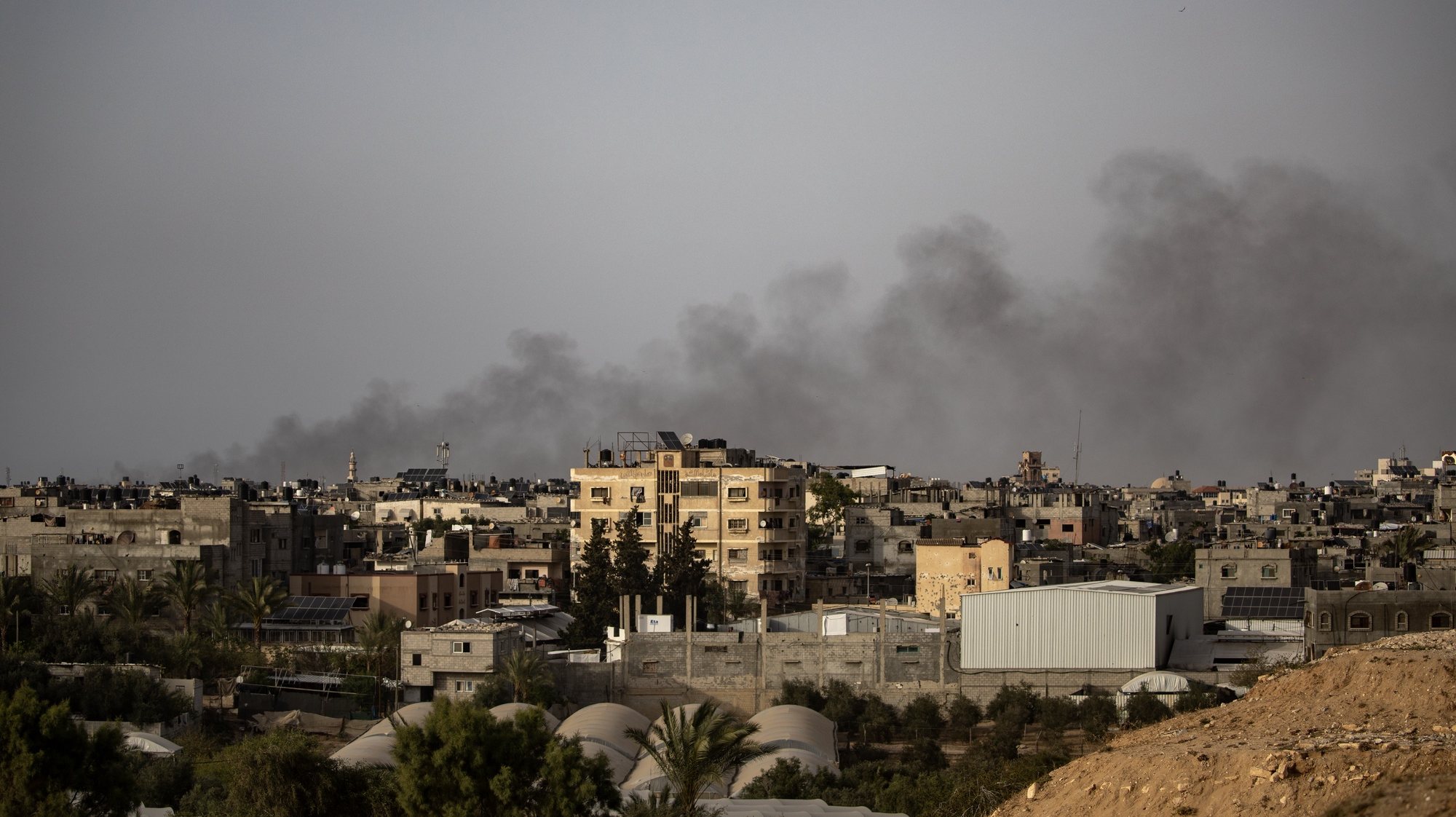 epa11290475 Smoke rises from Rafah refugee camp, in Rafah, southern Gaza Strip, 20 April 2024, after an Israeli air strike. More than 34,000 Palestinians and over 1,450 Israelis have been killed, according to the Palestinian Health Ministry and the Israel Defense Forces (IDF), since Hamas militants launched an attack against Israel from the Gaza Strip on 07 October 2023, and the Israeli operations in Gaza and the West Bank which followed it.  EPA/HAITHAM IMAD