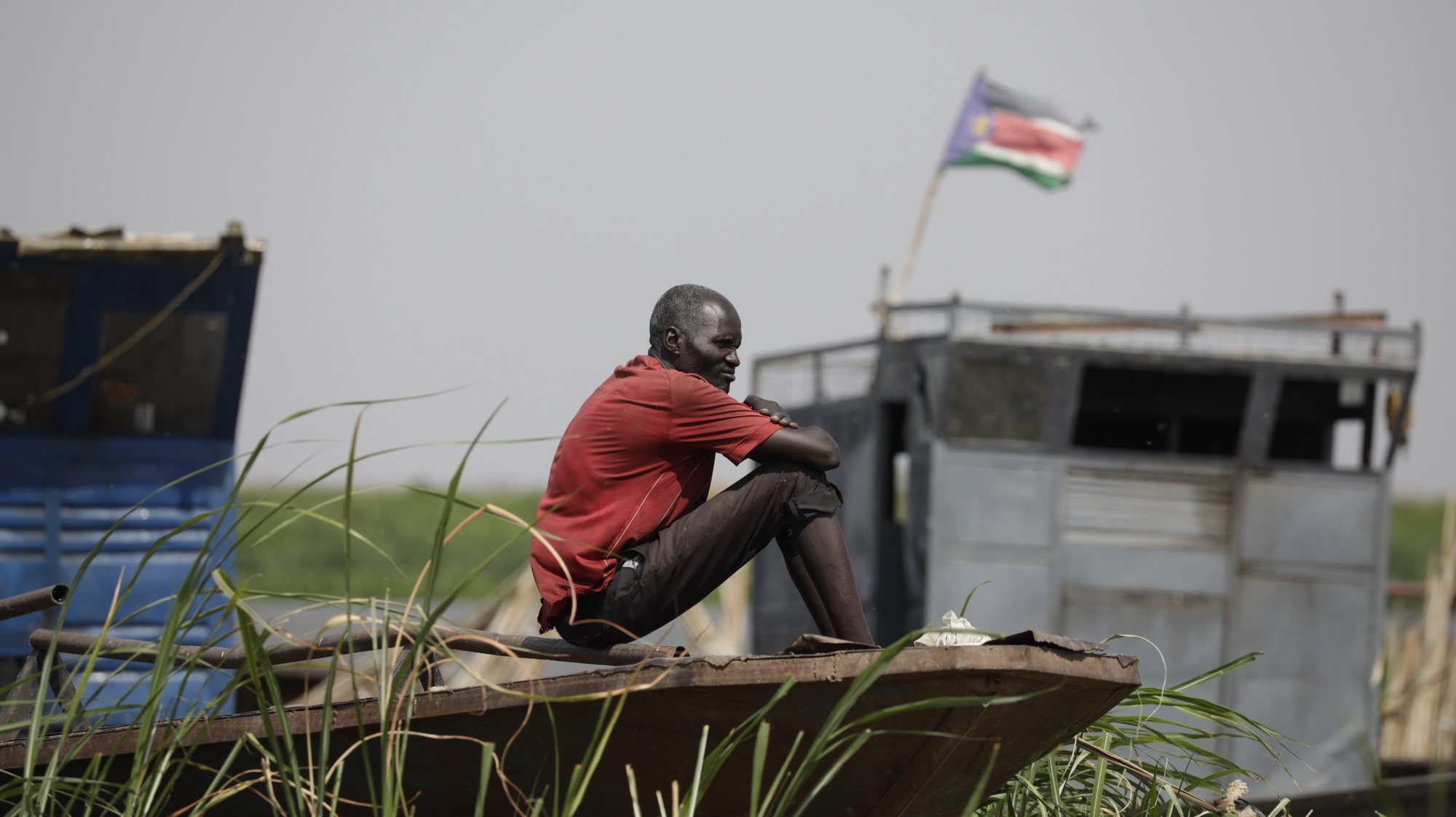 epa10629414 A South Sudanese man looks on as he sits on a boat on the Nile river at the fluvial port of Renk, in the Upper Nile State town of Renk, South Sudan, 14 May 2023 (issued 15 May 2023). According to Mohajer Mhadi Khalifa, head of the boats union in charge of regulating the transport on the Nile in Renk, five boats are planned to transport the returnees to their areas of origin on the Nile towards the Southern Town of Malakal and other locations. On 14 May 2023 a group of 348 people embarked for the trip, following 577 others who made the same trip the previous day after days of waiting in the fluvial port of Renk. The transport was coordinated and organized by the IOM, Caritas and the RCC (the South Sudanese Relief and Rehabilitation Commission). According to the United Nations, some 200,000 people have fled the conflict in Sudan between 15 April and 12 May 2023. Most of them left towards neighboring countries such as Egypt, Tchad, South Sudan or Ethiopia, and about two million people were internally displaced. Leaving behind them the armed conflict between the Sudanese military and the RSF (Rapid Support Forces) militia, most of the refugees in South Sudan are South Sudanese returnees, part of the some 800,000 who had previously fled the war in South Sudan and who are now returning to a country which is barely out of conflict itself with tensions still remaining in many areas.  EPA/AMEL PAIN ATTENTION: This Image is part of a PHOTO SET