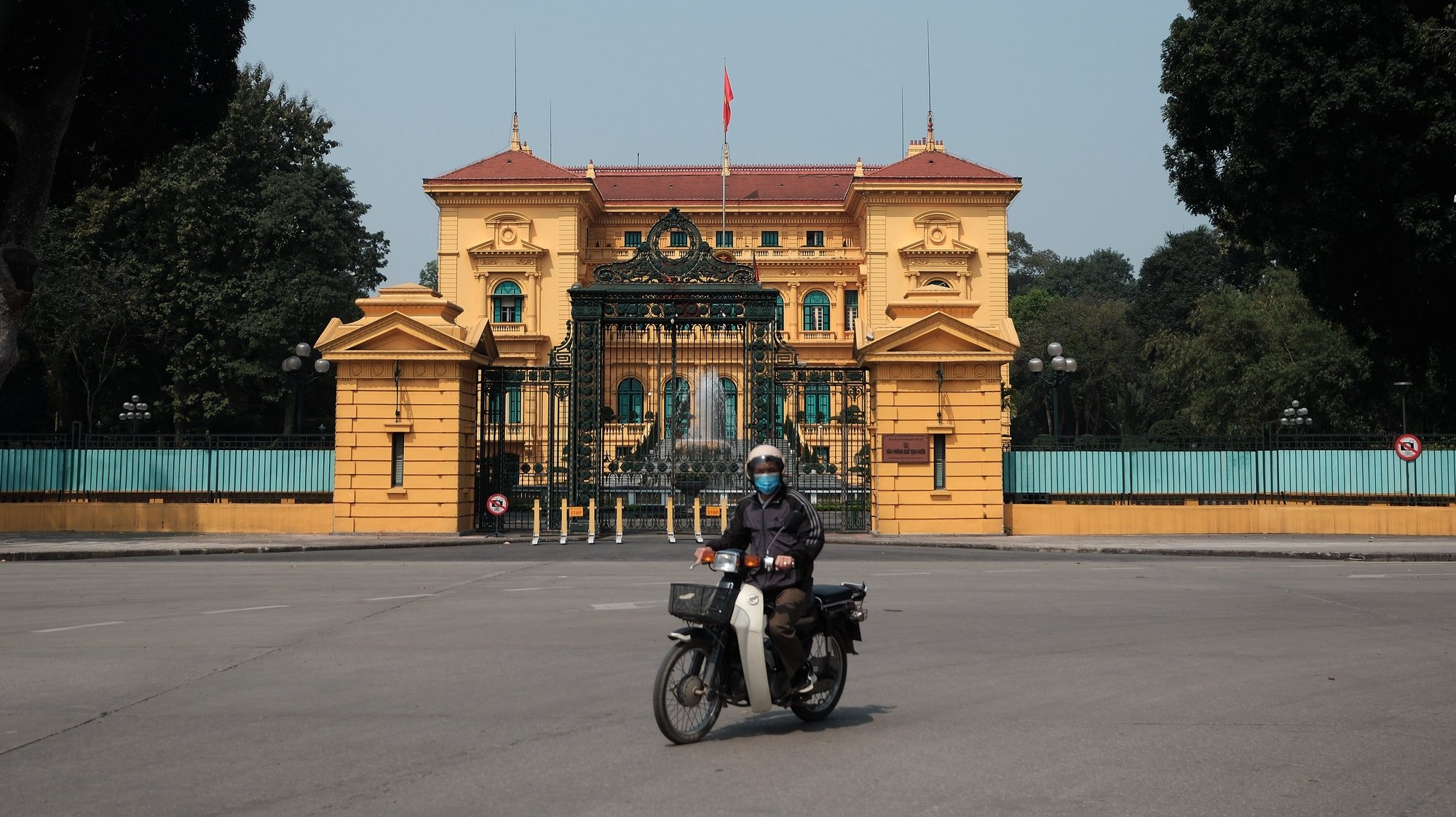 epa11232917 A man rides a motorbike past the Presidential Palace in Hanoi, Vietnam, 21 March 2024. Vietnam&#039;s Communist Party Central Committee has approved Vo Van Thuong&#039;s request to resign from positions, including President, Politburo member, 13th Party Central Committee, and Defense and Security Council President.  EPA/LUONG THAI LINH