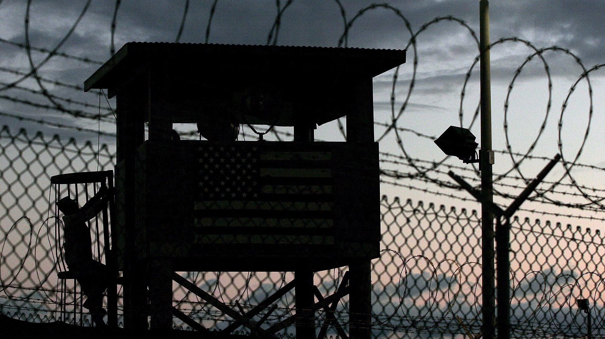epa05488797 (FILE) A file picture dated 16 February 2006 shows a Joint Task Force member (L, silhouetted) climbing to his guard tower post surrounded by triple rows of razor barbed wire that perimeter the security of Camp Delta, Guantanamo Naval Sation, Cuba. According to media reports on 16 August 2016, the US has sent 15 Guantanamo Bay (GTMO) inmates, 12 Yemenis and three Afghanis, to the United Arab Emirates (UAE). The transfer, the largest under US president Barack Obama&#039;s administration, has brought the total number of prisoners in the US military prison down to 61, media added quoting the Pentagon.  EPA/JOHN RILEY