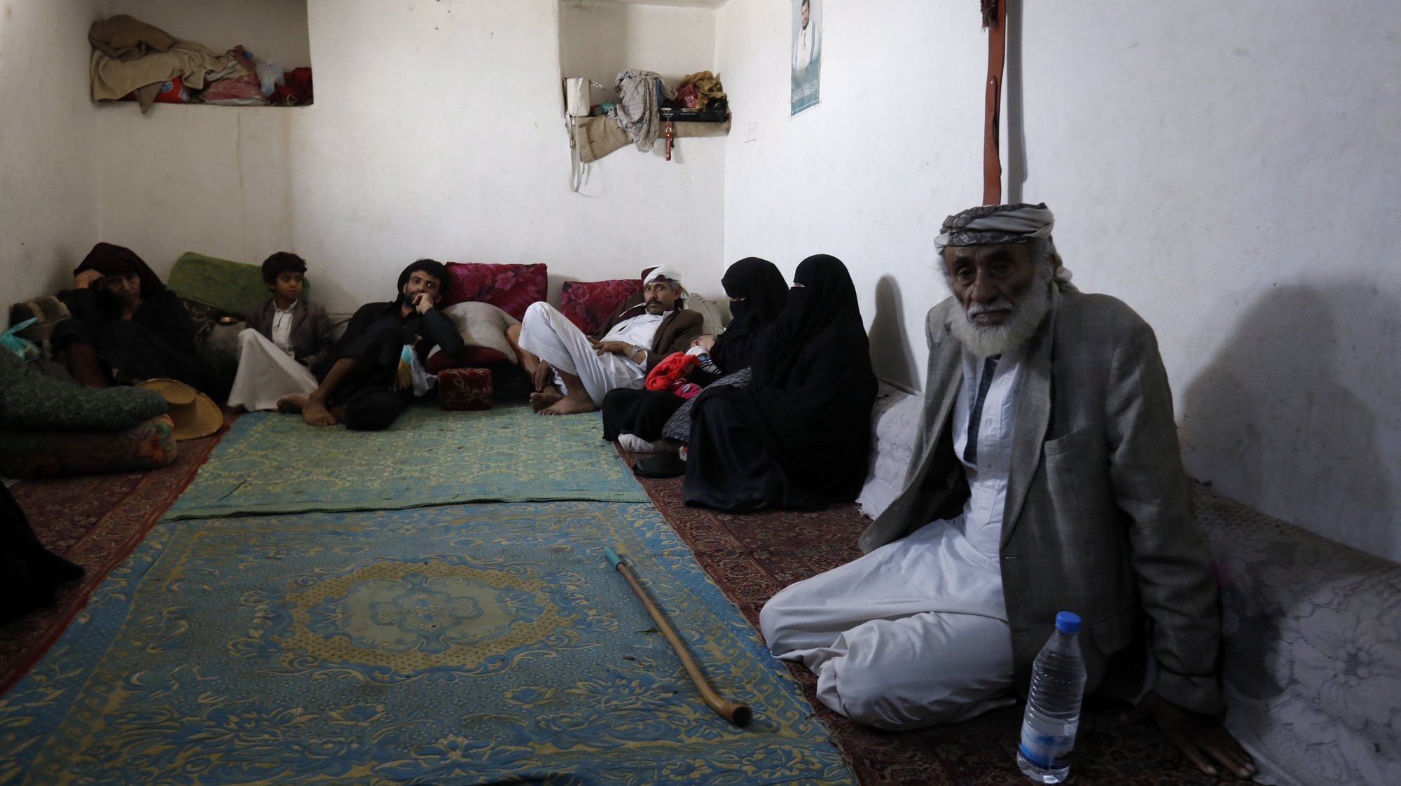 epa08495615 Yemeni displaced Mohammed Ahmed, 77, (R) and his relatives sit in a rental house in Sanaa, Yemen, 18 June 2020 (issued 19 June 2020). He says &#039;I have been displaced from the city of Haradh, northwestern Yemen, since 2016 due to the war that destroyed homes and roads. We displaced to Sanaa, leaving our properties there. We had no choice but to do so. We have no income except what we earn from collecting and selling plastic items. We receive a food ration from the World Food Programme once in every two months. It is not enough for a family of eight&#039;. World Refugee Day is marked annually on 20 June. According to the UNHCR, more and more refugees today live in urban settings outside refugee camps. Some crises have lasted so long that the tent camps became built-up urban areas. While some refugees depend on international help through NGOs, others start a new life, changing everything from occupation, to social status, to adapt to their new realities.  EPA/YAHYA ARHAB  ATTENTION: This Image is part of a PHOTO SET