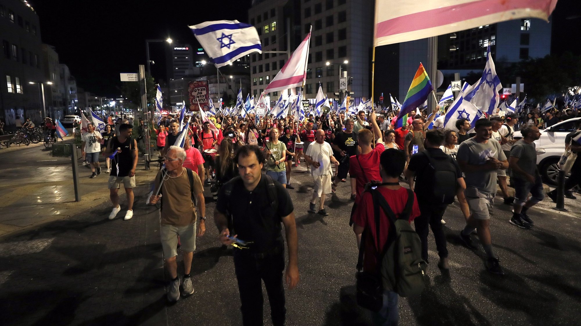 epa10772081 Anti-government demonstrators march during a protest against the Israeli judicial reform, in Tel Aviv, Israel, 27 July 2023. The Israeli parliament, or Knesset, passed a bill on 24 July that limits the Supreme Court&#039;s powers.  EPA/ATEF SAFADI