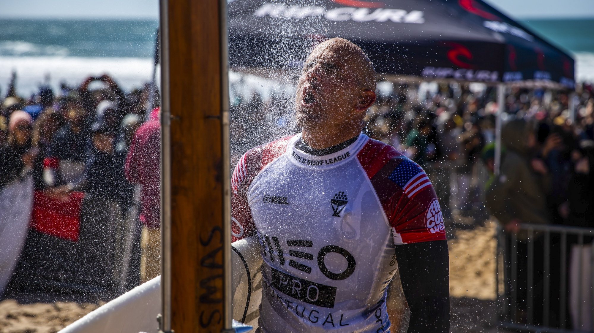 epa09805610 US surfer Kelly Slater takes a shower after losing his round of 16 heat at the Meo Pro Portugal surfing event as part of the World Surf League (WSL) World Tour at Supertubos beach in Peniche, Portugal, 06 March 2022.  EPA/JOSE SENA GOULAO