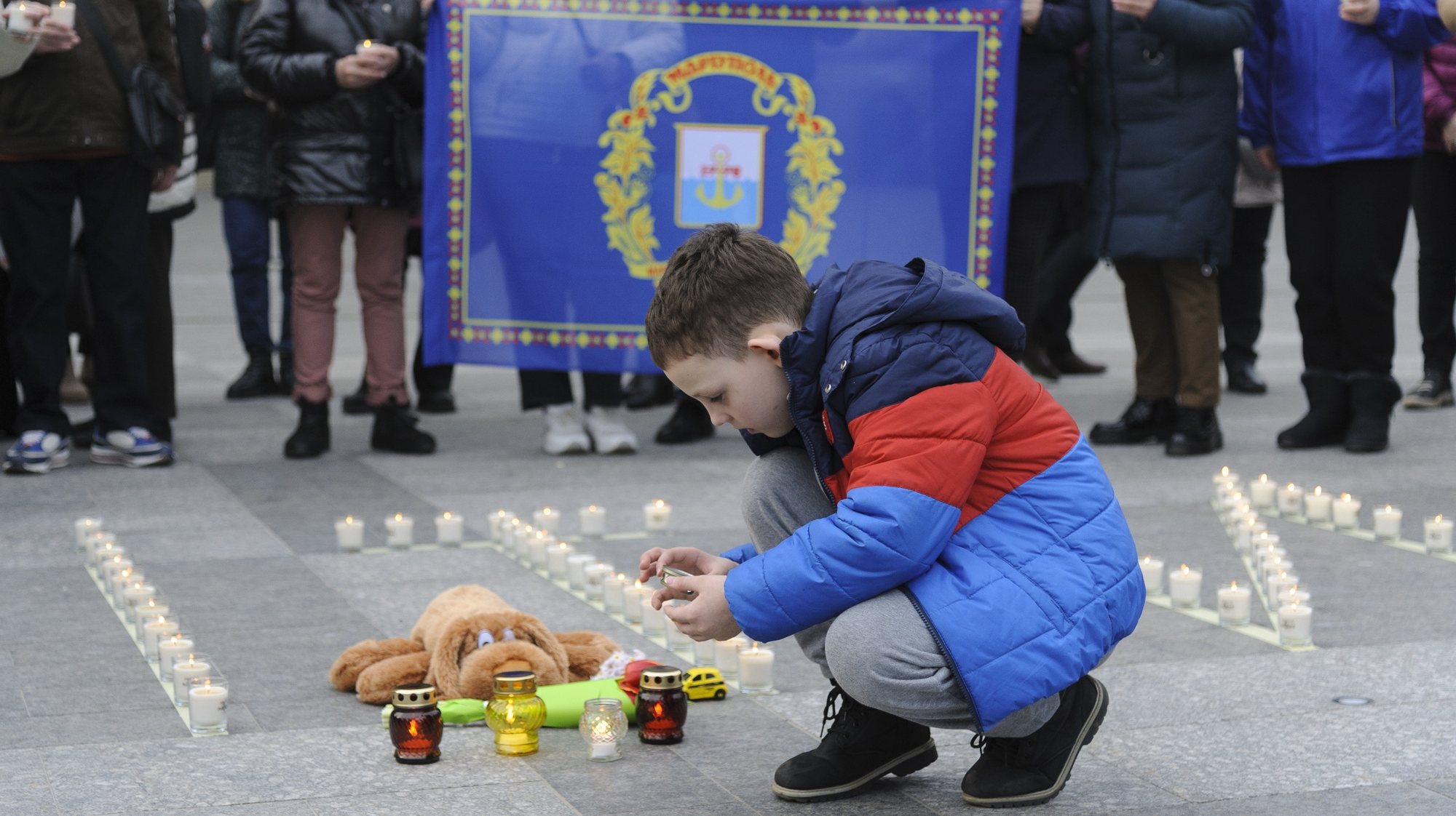 epa11224456 A boy lights a candle as people attend a commemorative rally to mark the second anniversary of the shelling of the Mariupol Drama Theatre, in front of the Opera theatre in Western Ukrainian city of Lviv, 16 March 2024. The Drama Theater was destroyed on 16 March 2022 during Russian airstrikes and the siege of the southern Ukrainian port city of Mariupol. According to Amnesty International Ukraine, at least 300 people died in the attack on the theatre, where a large number of civilians were hiding and the word &#039;children&#039; was written outside the building. Russian troops entered Ukrainian territory on 24 February 2022, starting a conflict that has provoked destruction and a humanitarian crisis.  EPA/MYKOLA TYS