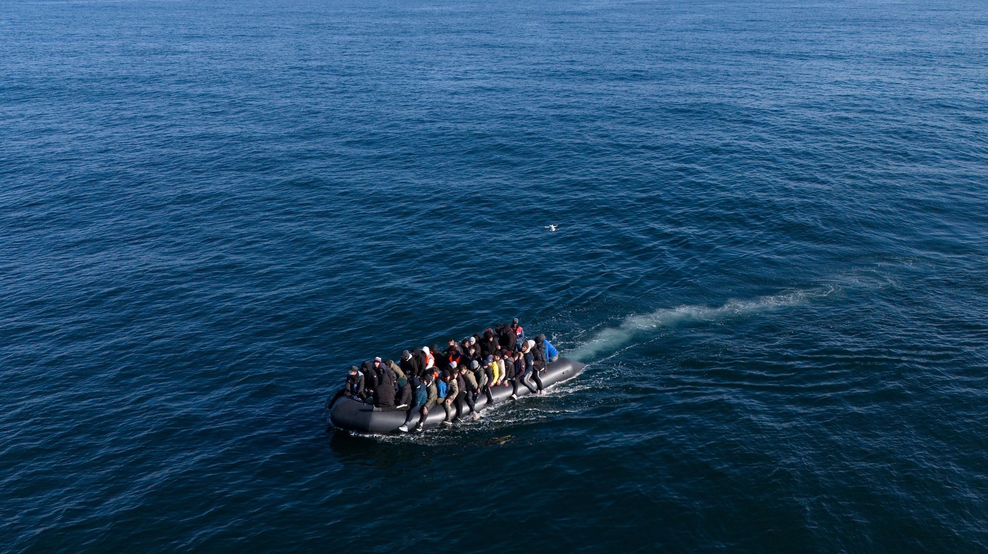 epaselect epa11201987 A picture taken with a drone shows migrants crossing the English Channel on a small boat, on 06 March 2024. The UK government has suffered more setbacks at the House of Lords recently on its plan to send migrants to Rwanda to deter the Channel crossings. Despite the British and French government&#039;s efforts to prevent migrants from making the dangerous journey on small boats, many are willing to take the risk to claim asylum in the UK.  EPA/TOLGA AKMEN