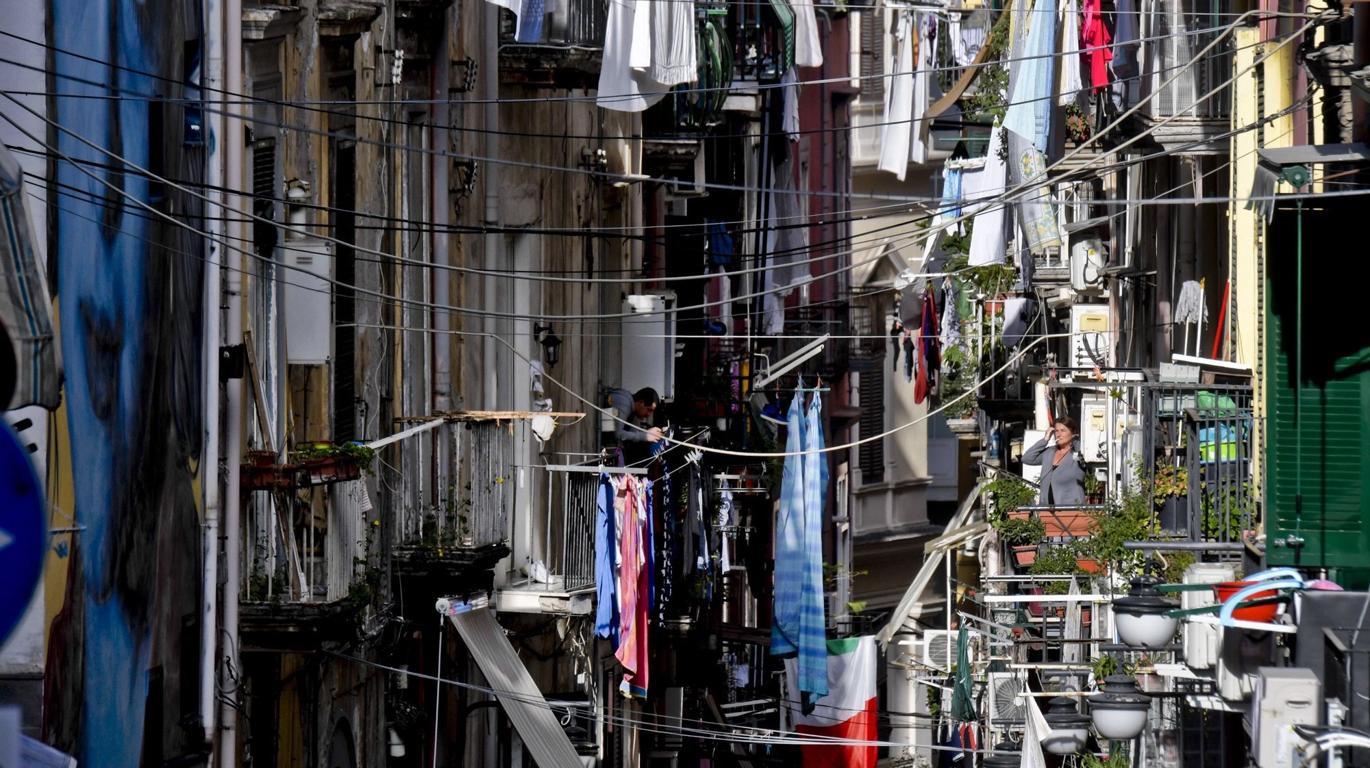 epa08369469 Clothes hang out for drying over a narrow alley during the nation-wide coronavirus lockdown, Naples, southern Italy, 17 April 2020. Countries around the world take measures to stem the spread of the SARS-CoV-2 coronavirus which causes the Covid-19 disease.  EPA/CIRO FUSCO