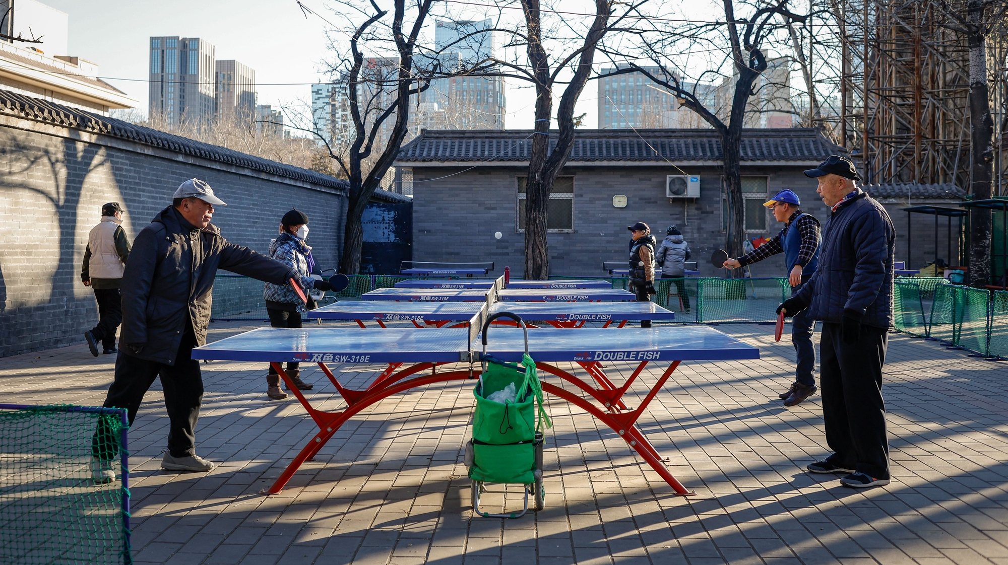 epa11095433 Elderly men (front) play table tennis at a park in Beijing, China, 22 January 2024. China&#039;s State Council issued a document with 26 guidelines calling on both government and private enterprises to develop industrial parks and increase public and private investments and innovation in elderly products and services as the country&#039;s population continues to decline.  EPA/MARK R. CRISTINO