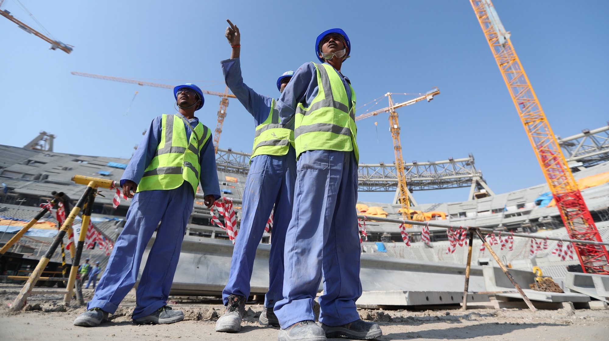 epa08083065 Construction workers at Lusail  Stadium during a media tour in Doha, Qatar, 20 December 2019. Lusail Stadium is one of the eight stadiums build for the FIFA World Cup 2022 in Qatar.  EPA/ALI HAIDER