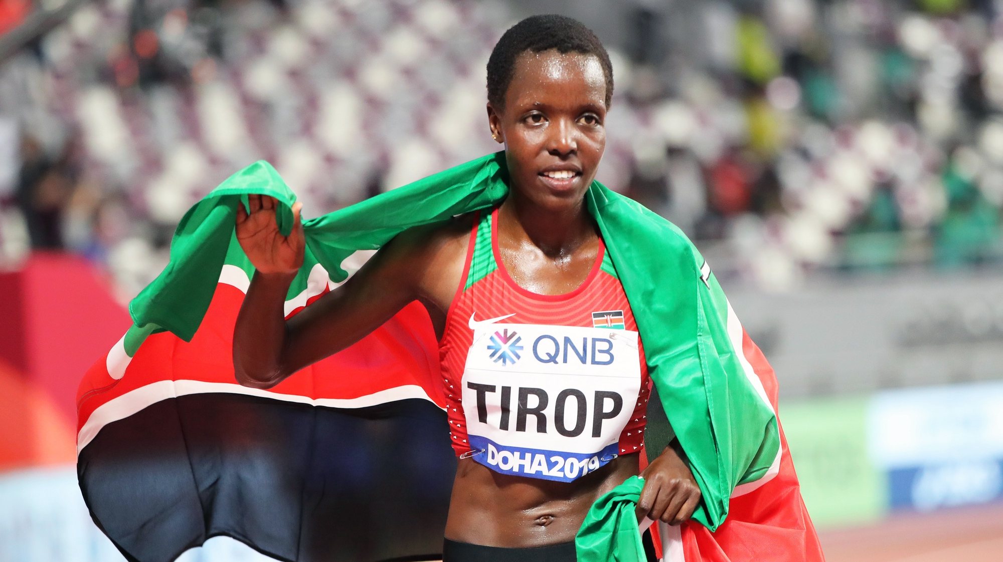 epa07878182 Agnes Jebet Tirop of Kenya celebrates after taking the third place in the women&#039;s 10,000m final during the IAAF World Athletics Championships 2019 at the Khalifa Stadium in Doha, Qatar, 28 September 2019. EPA/ALI HAIDER