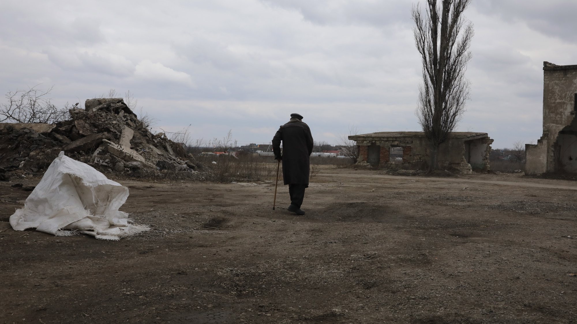 epa09821376 A Ukrainian elderly man who fled heavy fighting in Kherson heads  towards a tent area  to rest (not seen in the picture), at the refugees reception center, near Palanca, Moldova, 13 March 2022. Refugees upon their entry to Moldova board a minibus to a nearby reception center where they receive a warm drink then embark on a trip to the capital Chisinau, Poland, or Germany. Seventeen days into the Russian invasion of Ukraine the numbers of refugees fleeing the conflict to neighboring countries continues to increase, according to the UNHCR. Moldova has until 13 March received about 299,573 refugees, some 198,897 left to other EU countries and 100,676 chose to stay. The same day, residents of the Ukrainian cities Nykolaiv, Odessa and areas nearby continue to stream into Moldova while a few others went back to Ukraine, either because they want to bring more personal items, to check on their property, or because they feel overwhelmed and want to return home in spite of the danger.  EPA/AMEL PAIN