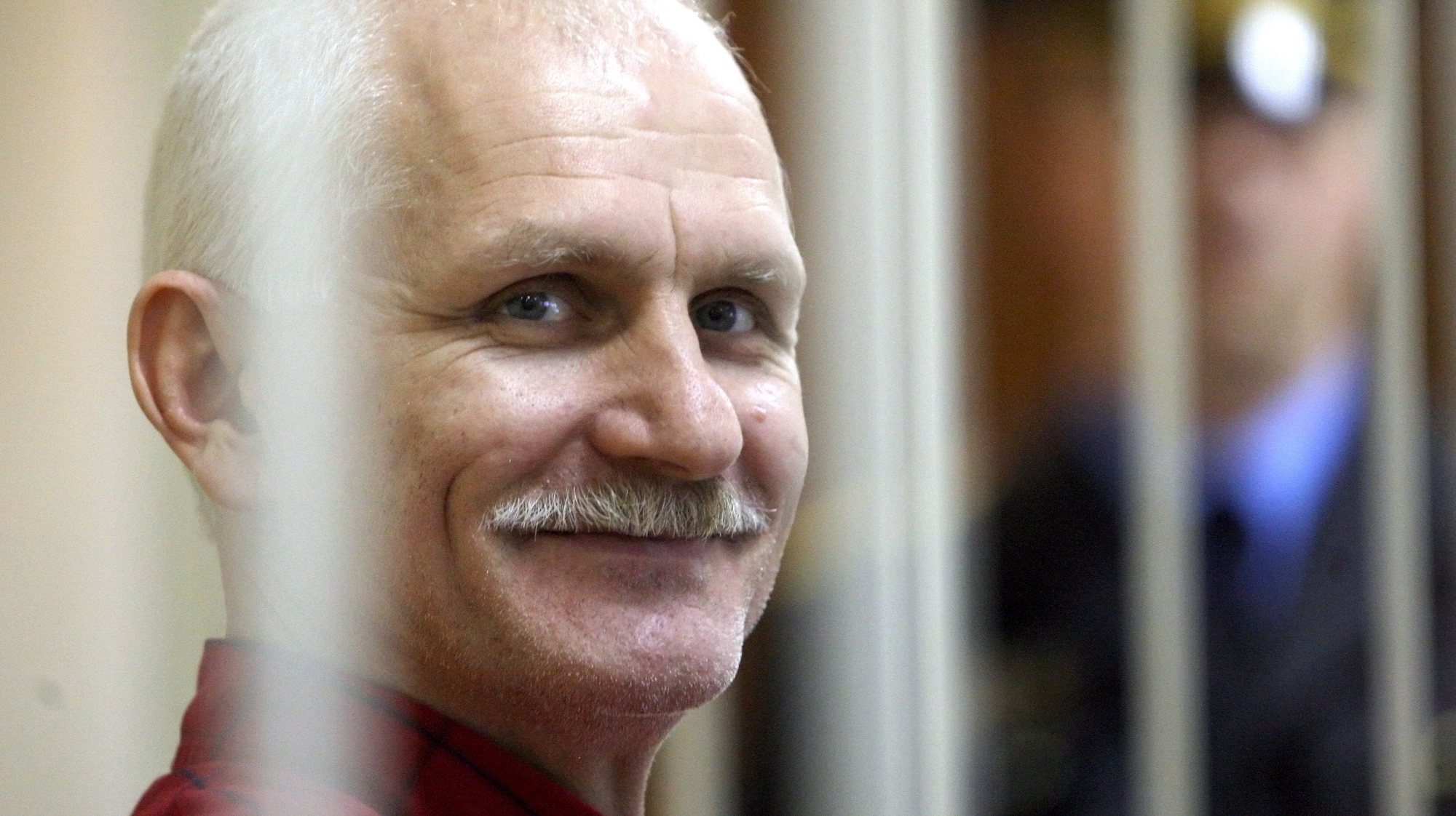 epa10228770 (FILE) - Belarusian human rights activist Ales Bialiatski (also transliterated as Alex Belyatsky), leader of Viasna, a human rights group based in Minsk, smiles as he waits in a trial cage inside a courtroom prior to a court session in Minsk, Belarus, 24 November 2011 (reissued 07 October 2022). The Nobel Peace Prize 2022 has been awarded to human rights advocate Ales Bialiatski from Belarus, the Russian human rights organization Memorial and the Ukrainian human rights organization Center for Civil Liberties. The Norwegian Nobel Committee said in a statement on 07 Octobe 2022, that by awarding the Nobel Peace Prize for 2022 to Bialiatski, Memorial and the Center for Civil Liberties, it wishes to &#039;honour three outstanding champions of human rights, democracy and peaceful co-existence in the neighbour countries Belarus, Russia and Ukraine.&#039; Bialiatski was imprisoned from 2011 to 2014 and following large-scale demonstrations against the Belarus regime in 2020, he was again arrested and still detained without trial, the Norwegian Nobel Committee added.  EPA/TATYANA ZENKOVICH *** Local Caption *** 50100352