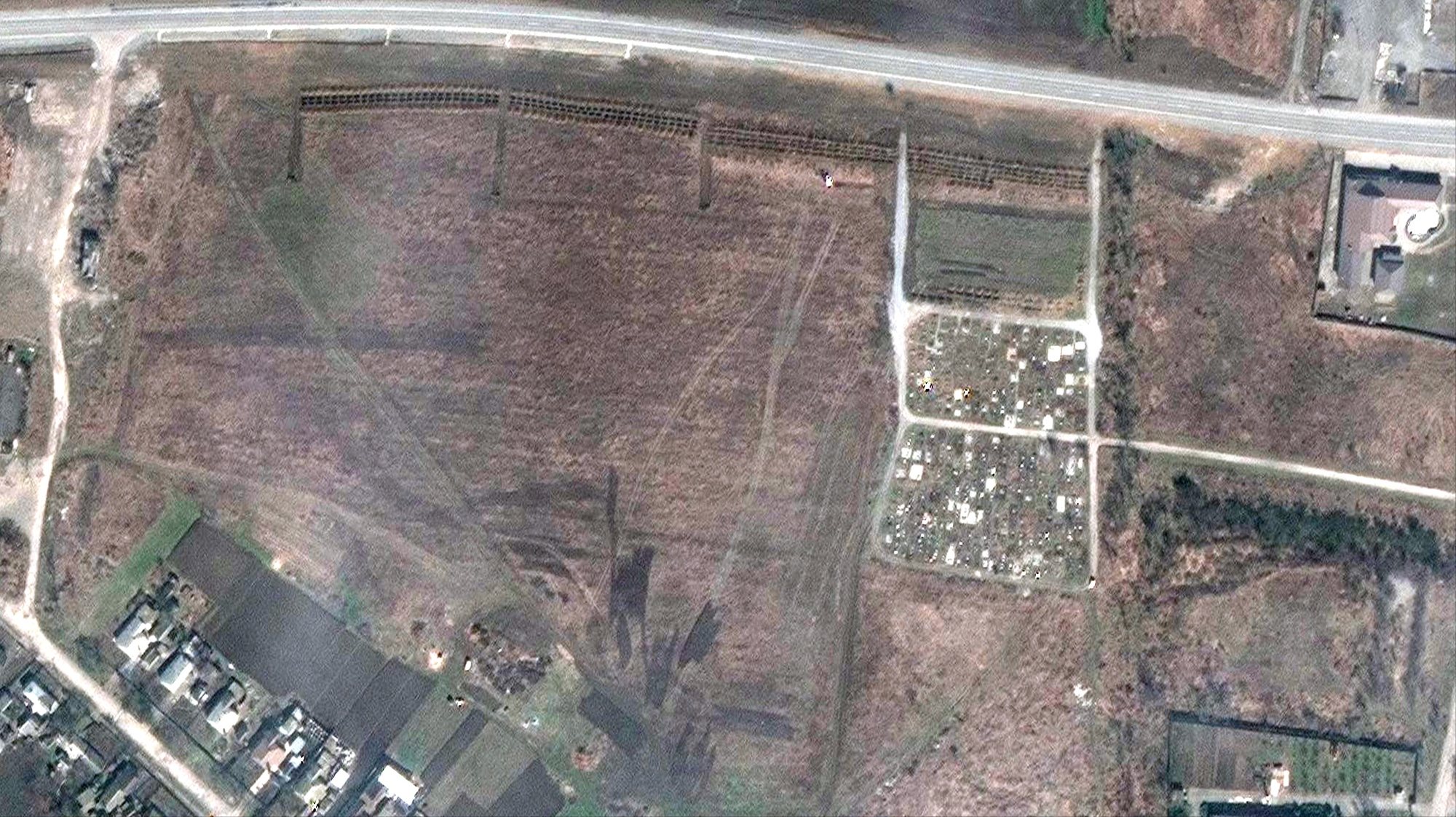 epa09900942 A handout satellite image made available by Maxar Technologies claims to show a mass grave site adjacent to an existing village cemetery on the northwestern edge of Manhush, some 20 kilometers west of Mariupol, Ukraine, 03 April 2022 (issued 21 April 2022). Maxar has reviewed satellite images from mid-March through mid-April, and indicate that the expansion of the new set of graves began between 23 to 26 March 2022 and continued to expand. The graves are aligned in four sections of linear rows (measuring approximately 85 meters per section) and contain more than 200 new graves, Maxar states.  EPA/MAXAR TECHNOLOGIES HANDOUT -- MANDATORY CREDIT: SATELLITE IMAGE 2022 MAXAR TECHNOLOGIES -- THE WATERMARK MAY NOT BE REMOVED/CROPPED -- HANDOUT EDITORIAL USE ONLY/NO SALES