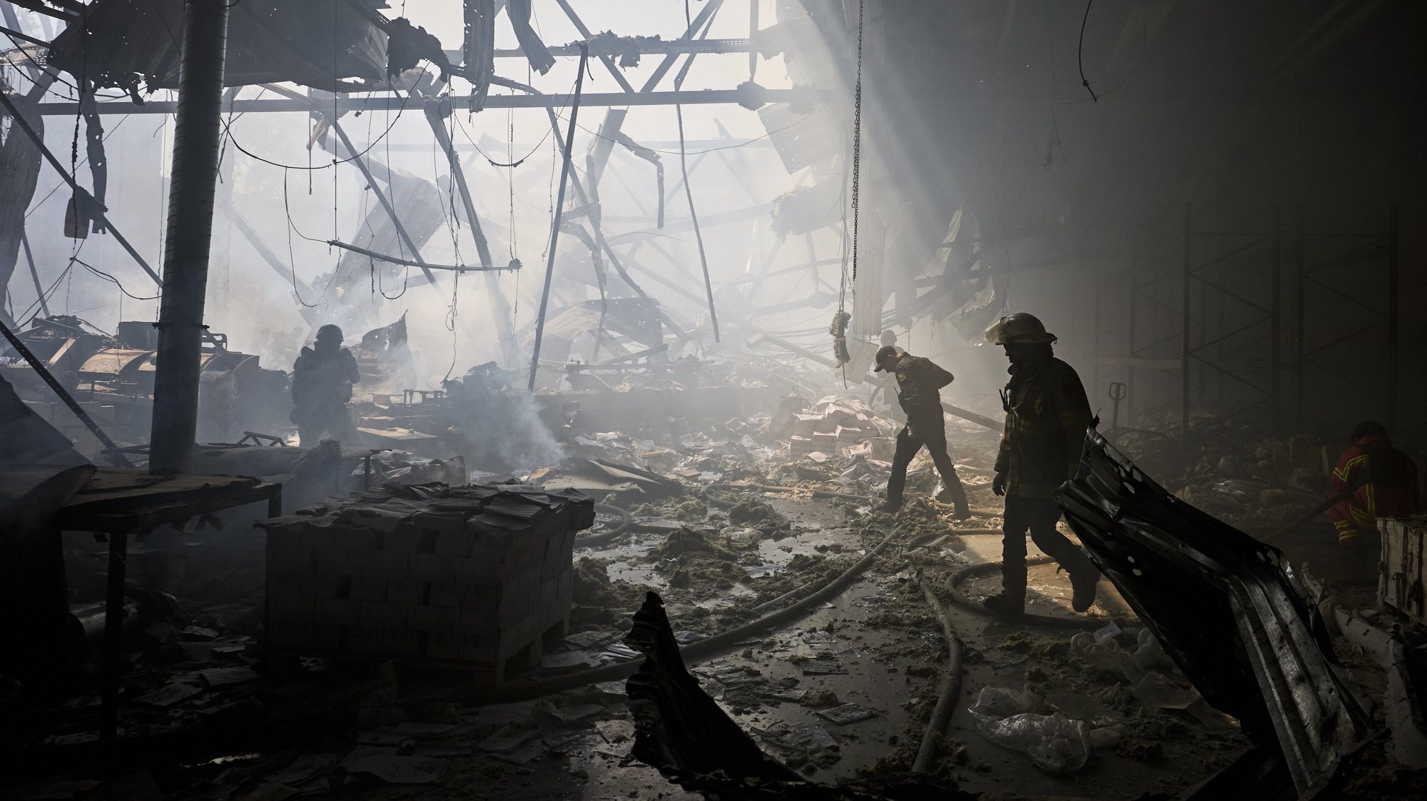 epaselect epa11363335 Ukrainian rescuers work at the site of a shelling on a printing house in Kharkiv, Ukraine, 23 May 2024, amid the Russian invasion. At least seven people were killed and 16 others were wounded in the rocket attack, according to the report of the head of the Kharkiv Military Administration Oleg Synegubov.  EPA/SERGEY KOZLOV