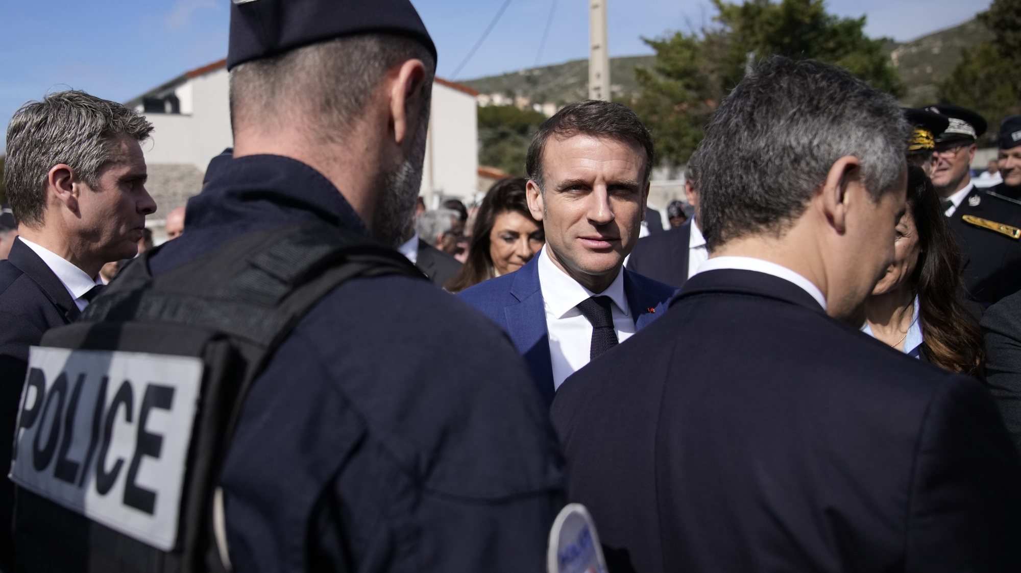 epa11229141 French President Emmanuel Macron (C) talks to police officers during a visit focused on security and the fight against drug trafficking, in La Castellane, district of Marseille, southern France, 19 March 2024.  EPA/CHRISTOPHE ENA / POOL MAXPPP OUT