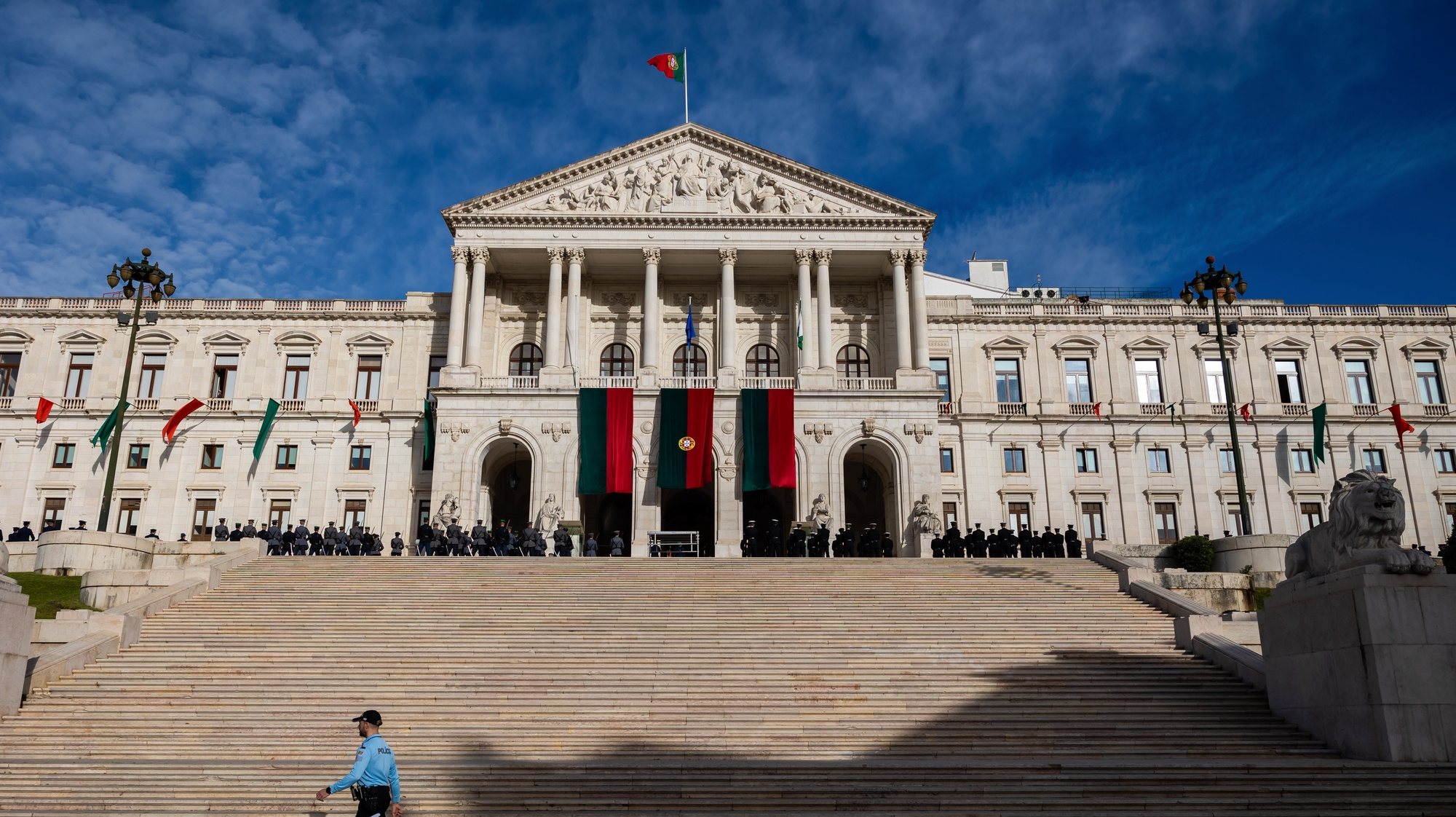 A police officer walks in front of the Portuguese Parliament before the Carnation Revolution 50th anniversary solemn comemorative session, in Lisbon, Portugal, 25 April 2024. Portugal celebrates the 50th anniversary of the Carnation Revolution that ended the authoritarian regime of Estado Novo (New State) that ruled the country between 1926 to 1974. JOSE SENA GOULAO/LUSA