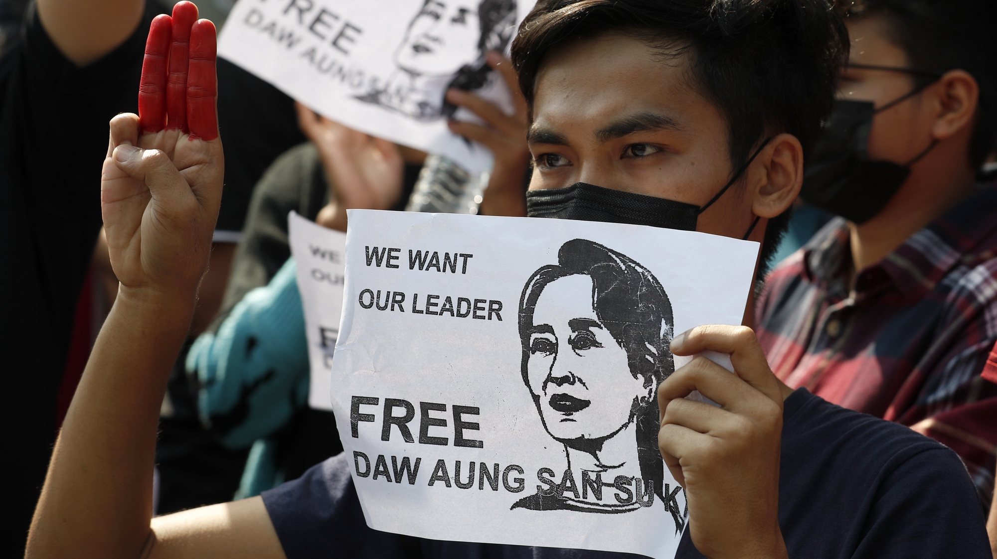 epa08993326 Protesters hold portraits of detained Myanmar State Counselor Aung San Suu Kyi reading &#039;We Want Our Leader Free&#039; and flash the three-finger salute, a symbol of resistance, during a protest against the military coup in Yangon, Myanmar, 07 February 2021. Thousands of people took to the streets of Yangon, Myanmar&#039;s biggest city, for a second day of mass protests against the military coup amid internet shut down imposed by military rulers. Myanmar&#039;s military seized power and declared a state of emergency for one year after arresting State Counselor Aung San Suu Kyi and Myanmar president Win Myint in an early morning raid on 01 February.  EPA/NYEIN CHAN NAING