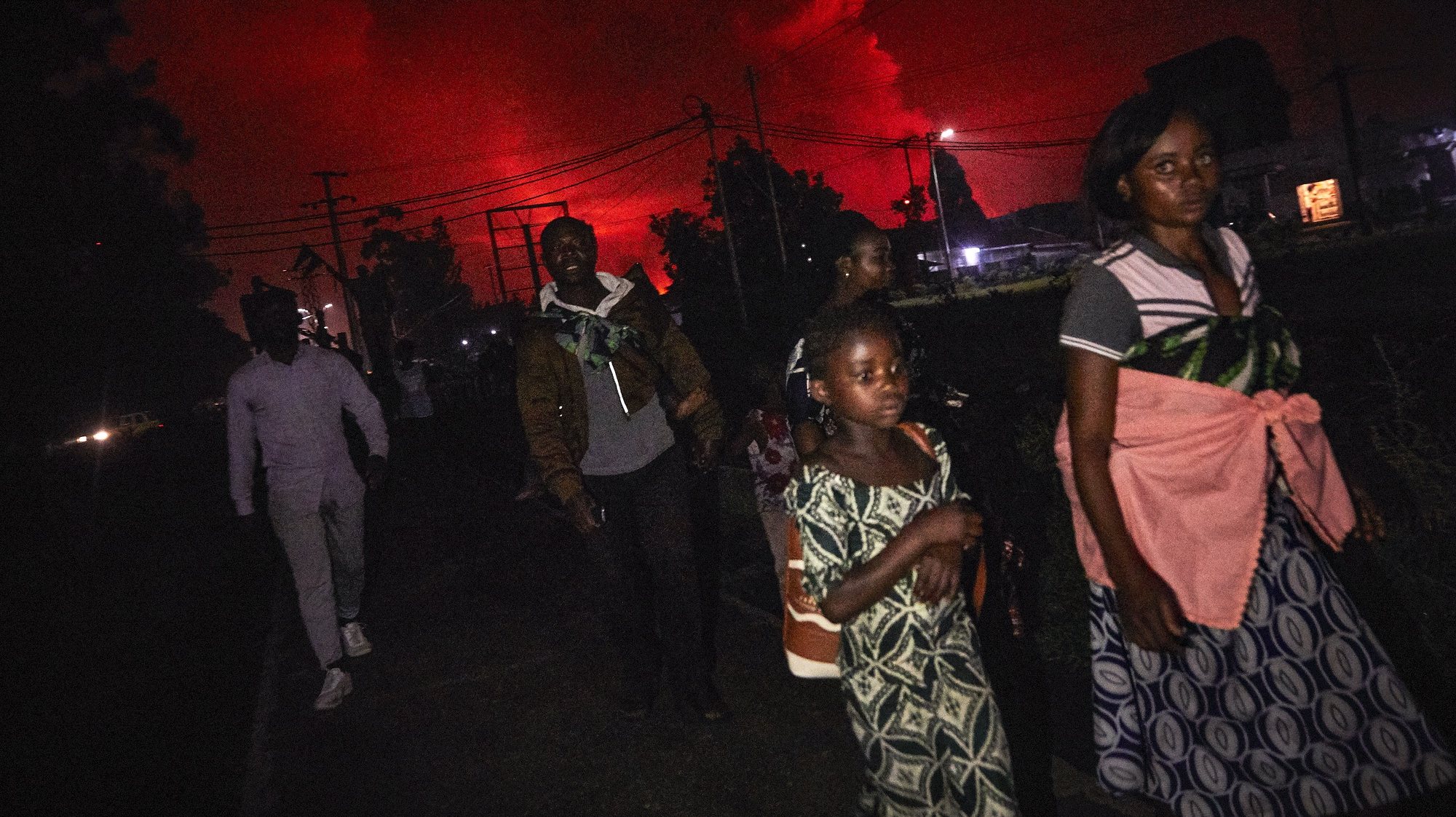 epaselect epa09221145 Congolese residents of Goma flee from Mount Nyiragongo volcano as it erupts over Goma, Democratic Republic of the Congo, 22 May 2021. One of the planets most active volcanoes Mount Nyiragongo in eastern Democratic Republic of Congo erupted causing evacuations in some parts of Goma. Initial reports from scientists predict the city is not in danger from the lava.  EPA/HUGH KINSELLA CUNNINGHAM