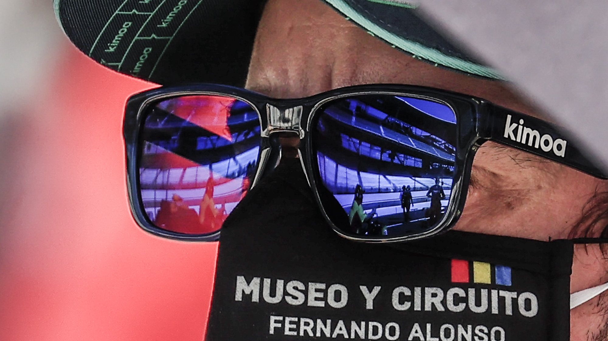 epaselect epa08606054 Empty grandstands are reflected in the sunglasses of Fernando Alonso of Spain as he waits for his turn to drive during qualifying for the Indianapolis 500 automobile race in Indianapolis, Indiana, USA, 15 August 2020. The race was schedule to be run on 24 May 2020 but was delayed because of Covid-19. The race is now to be run on 23 August without fans in attendance.  EPA/TANNEN MAURY