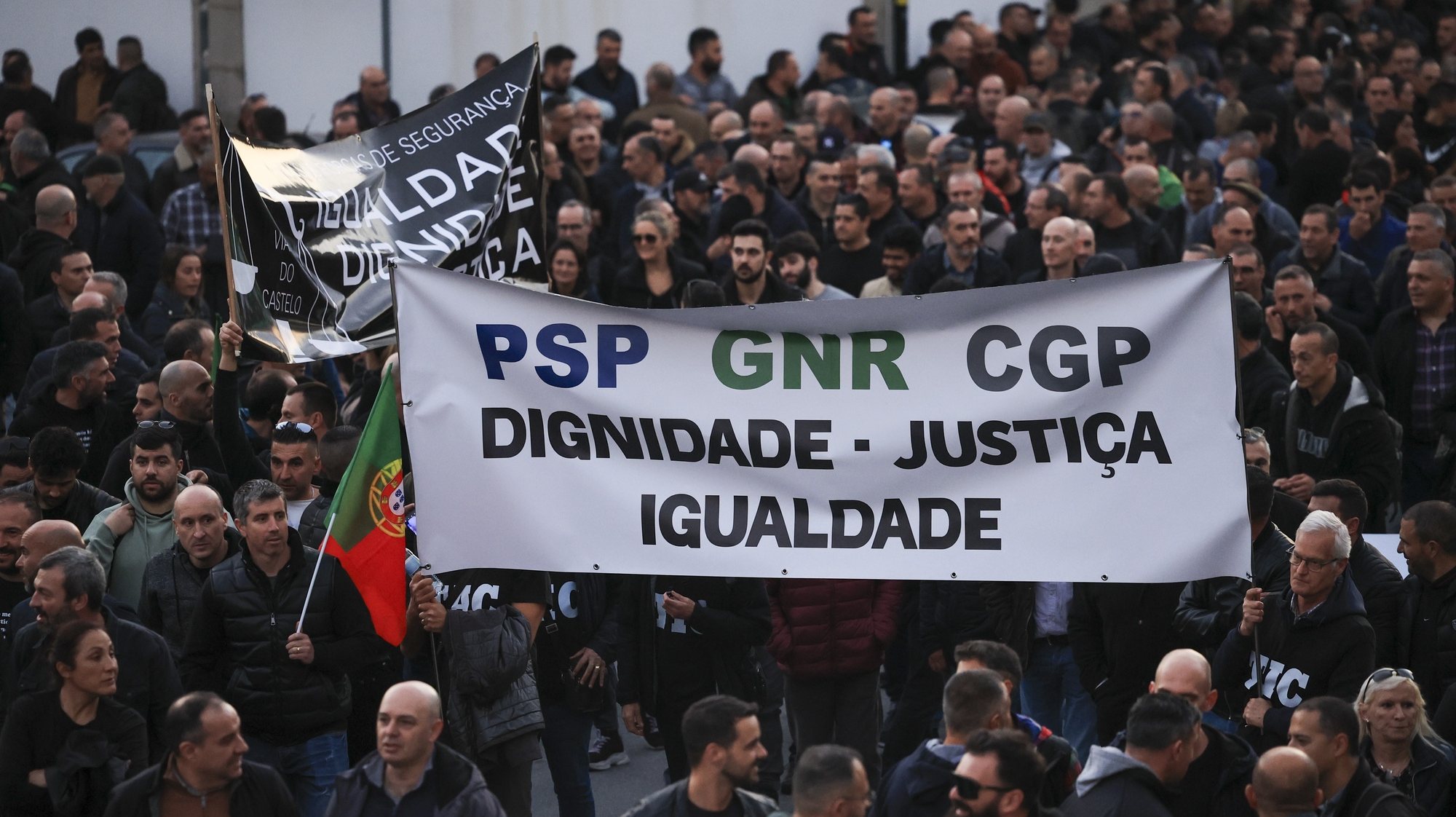 Police officers hold a banner with the words &quot;Dignity, Justice, Equality&quot; protest during a demonstration by the platform of PSP (Public Security Police) unions and GNR (National Republican Guard) associations for the restructuring of pay supplements and for the enhancement and dignification of professionals, Porto, Portugal, 31 January 2024.  ESTELA SILVA/LUSA