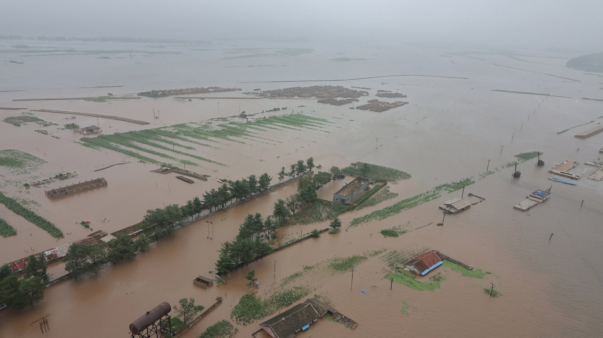 epa11504802 A photo released by the official North Korean Central News Agency (KCNA) shows a flood-hit area in North Phyongan Province, North Korea, 28 July 2024 (issued 29 July 2024). According to KCNA, a record downpour hit the northern border of North Korea and China on 27 July caused the water level of the Amnok River to far exceed the danger line, affecting more than 5,000 inhabitants in several islet areas of Sinuiju City and Uiju County of North Phyongan Province.  EPA/KCNA  EDITORIAL USE ONLY
