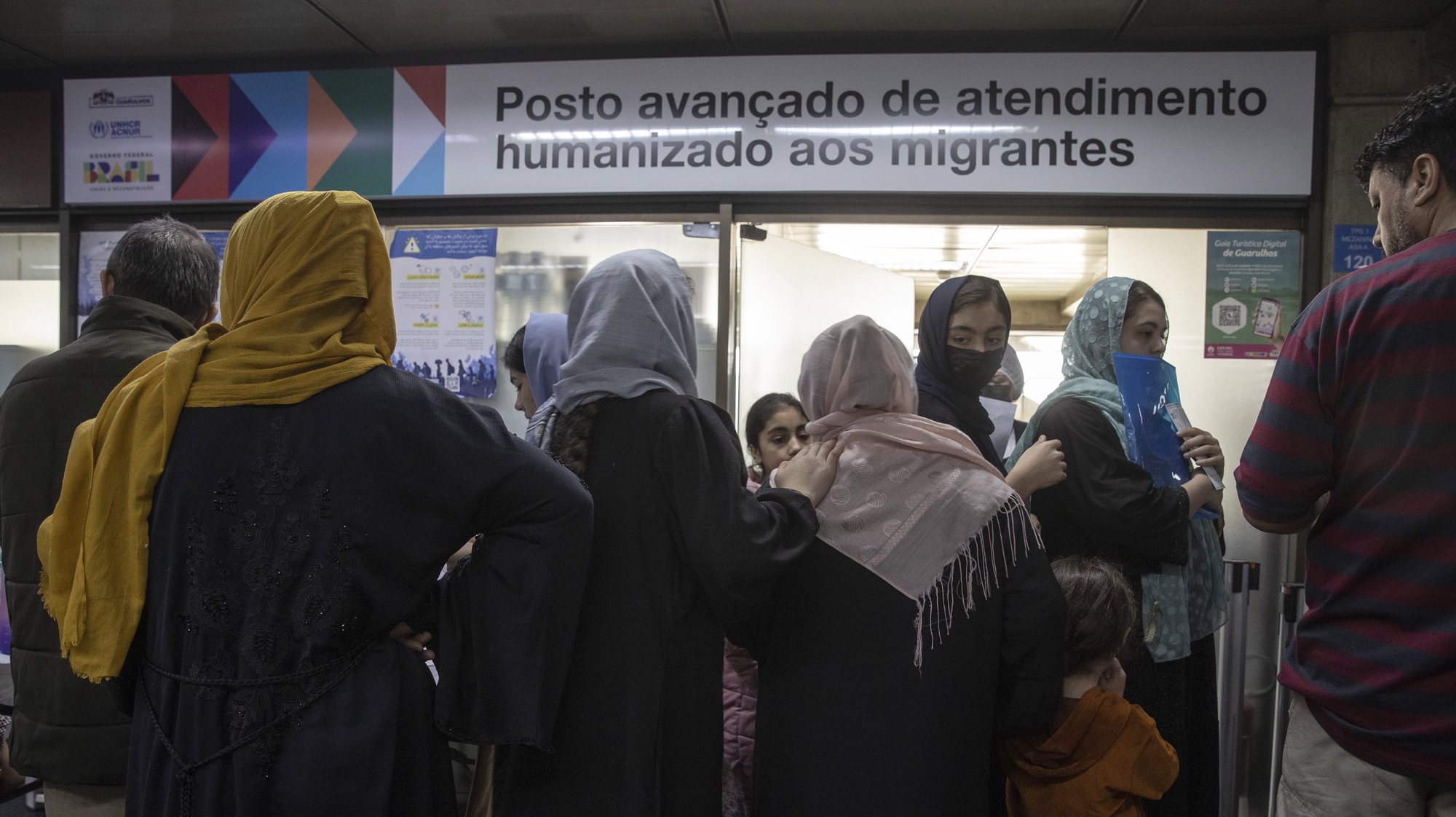 epa10718311 Afghan refugees queue at a migration assistance post, as they wait for authorities to offer them a place to rest, inside the international airport of Sao Paulo, Brazil, 29 June 2023. The sense of emergency has grown in recent days, after a doctor sent by the City Council discovered that a family in the camp had scabies infection. Since September 2021, the Brazilian government has offered a humanitarian visa to those fleeing the Taliban regime to allow them to travel to the South American country and, once there, apply for refugee status or a residence permit.  EPA/Sebastiao Moreira