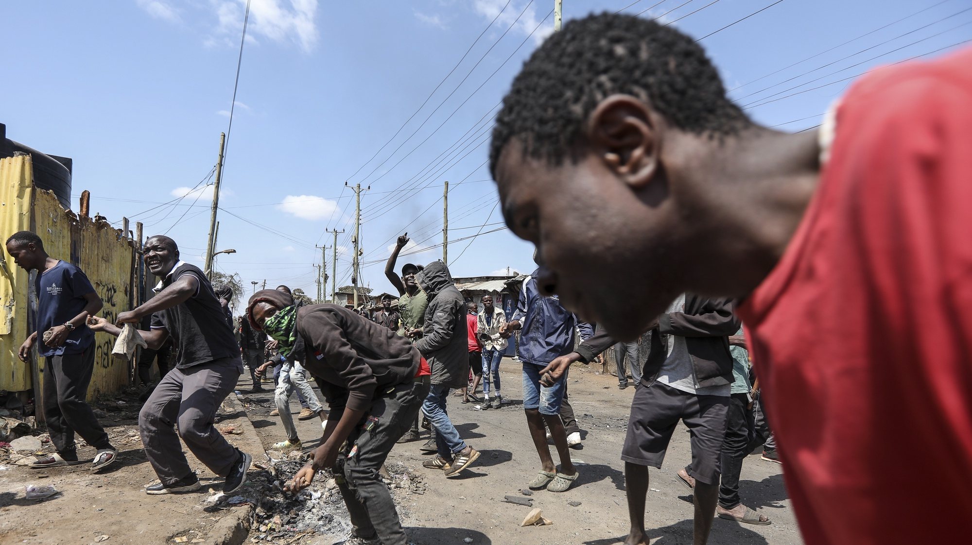 epaselect epa10759959 Protesters and supporters of the opposition Azimio coalition throw stones as they engage with riot police in running battles, during the third day of renewed nationwide protests in Nairobi, Kenya, 21 July 2023. Fresh nation-wide protests against the Kenyan government have been called by the Opposition coalition Azimio led by their opposition leader Raila Odinga, over high cost of living and new tax increases, that have been termed as punitive despite a court order stopping its implementations.  EPA/Daniel Irungu