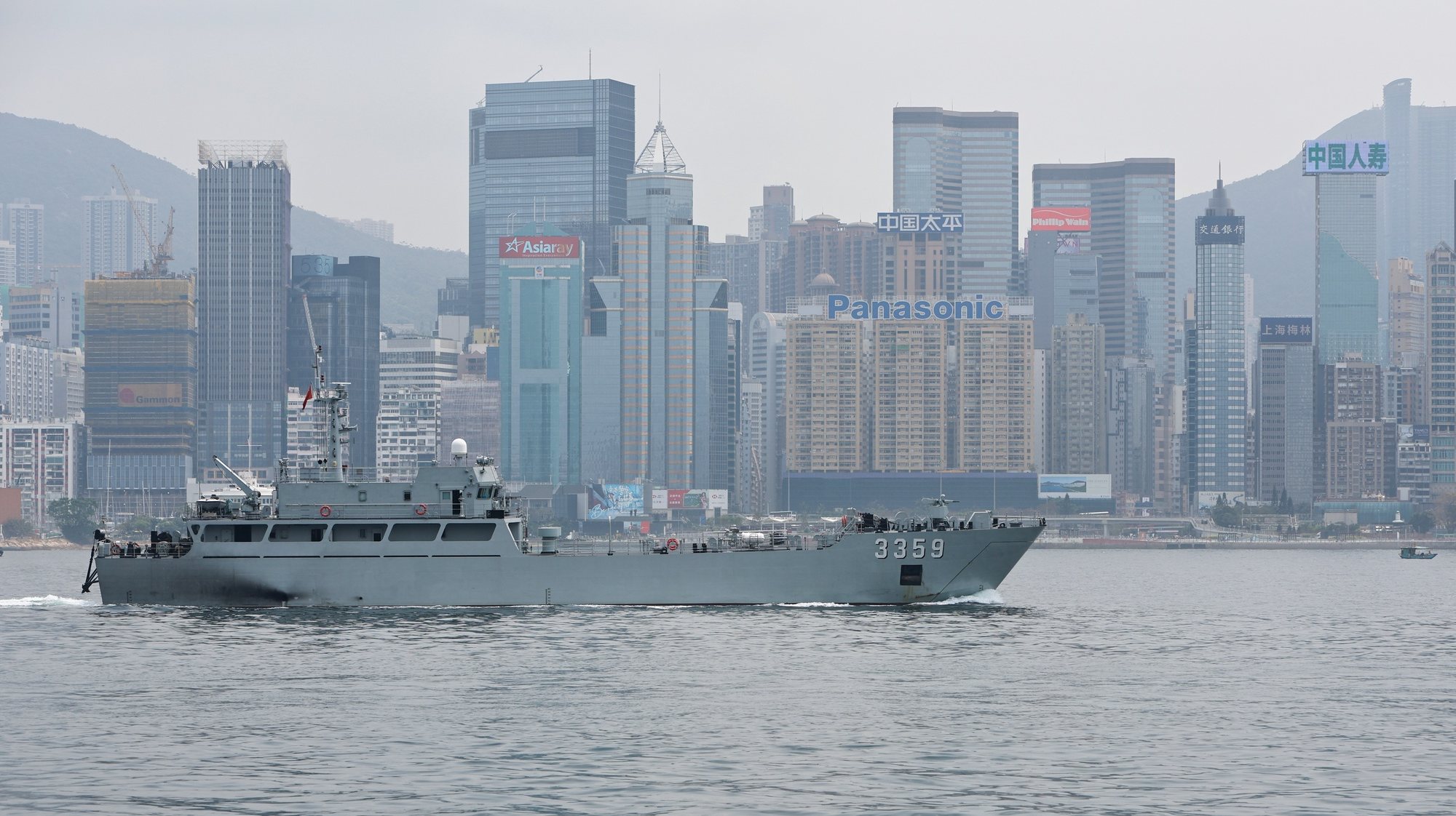 epa11249174 A Chinese military vessel sails through the Victoria Harbour against the backdrop of the Central Business District in Hong Kong, China, 29 March 2024. Foreign countries such as the United States, the United Kingdom, Australia and some European countries have expressed concerns over the city’s Article 23 and National Security Law, which are said to have impacts on business, freedom of speech, freedom of the press and other human rights.  EPA/DANIEL CENG