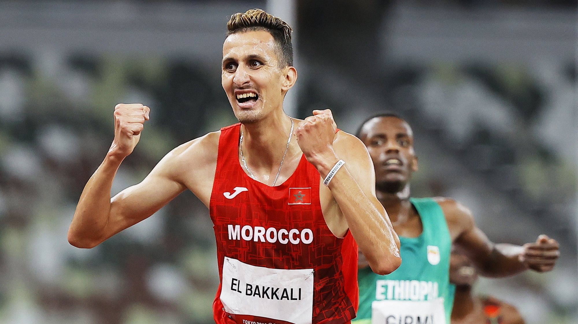 epa09388089 Soufiane El Bakkali of Morocco wins the Men&#039;s 3000m Steeplechase final at the Athletics events of the Tokyo 2020 Olympic Games at the Olympic Stadium in Tokyo, Japan, 02 August 2021. Lamecha Girma of Ethiopia placed second.  EPA/VALDRIN XHEMAJ