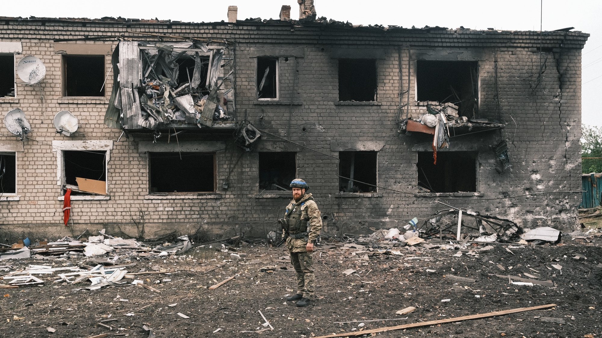 epa11336743 A Ukrainian police officer inspects a damaged building during the evacuation of local people from territories bordering Russia, in the city of Vovchansk, Kharkiv region, northeastern Ukraine, 13 May 2024, amid the Russian invasion. More than 4,000 residents from settlements in areas of the Kharkiv region bordering Russia have been evacuated as &#039;hostilities intensified&#039;, the head of the Kharkiv Military Administration Oleg Synegubov wrote on telegram. The evacuations follow a cross-border offensive by Russian forces, who claimed the capture of several villages in the region. Russian troops entered Ukrainian territory on 24 February 2022, starting a conflict that has provoked destruction and a humanitarian crisis.  EPA/GEORGE IVANCHENKO