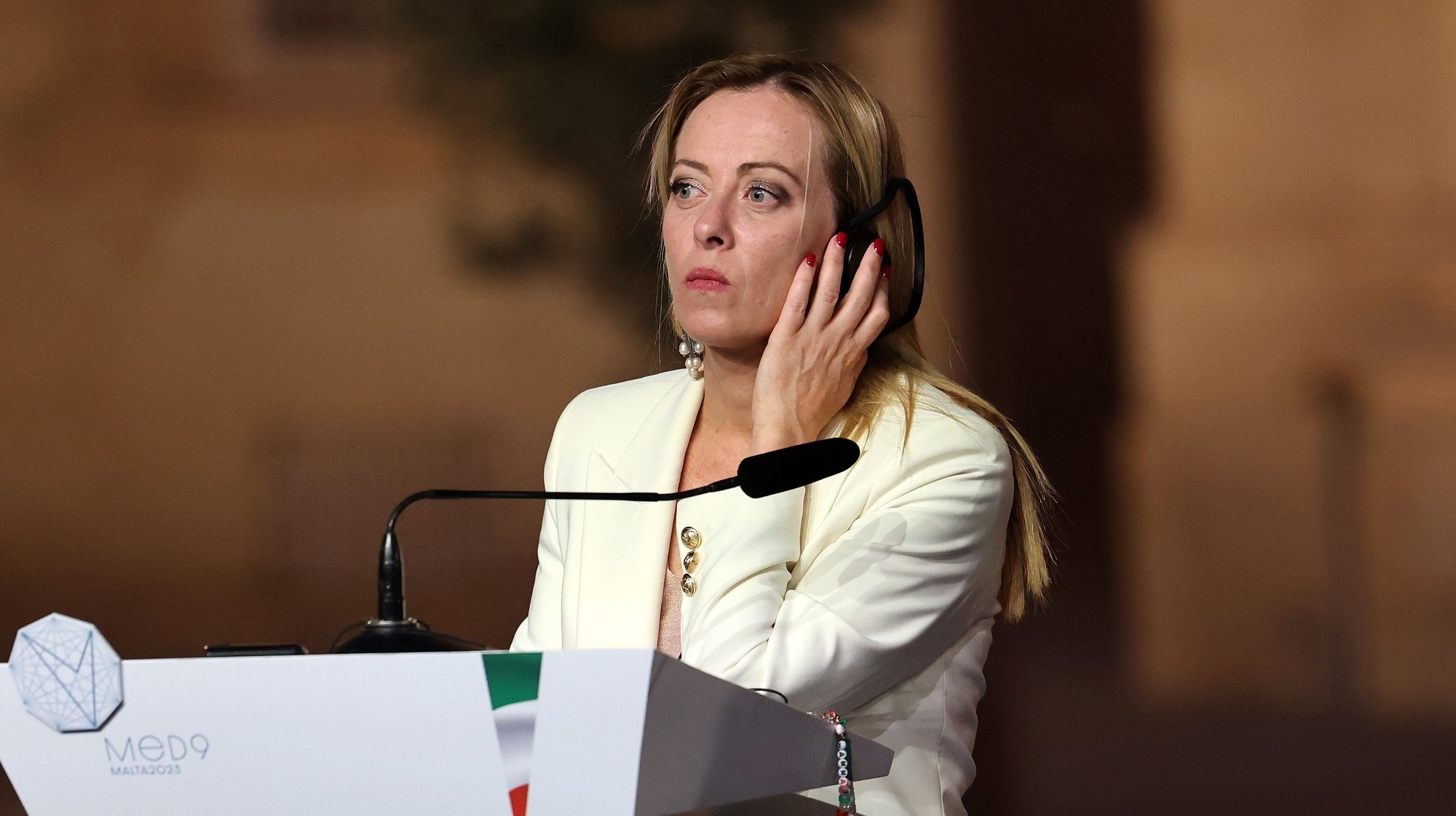 epa10890662 Italian Prime Minister Giorgia Meloni listens as she takes part in a press conference at the 10th Summit of the Leaders of the Southern Countries of the European Union, in Valletta, Malta, 29 September 2023. The EU-Med9 meeting brings together the leaders or representatives of Spain, Portugal, France, Italy, Greece, Malta, Cyprus, Slovenia and Croatia.  EPA/Domenic Aquilina
